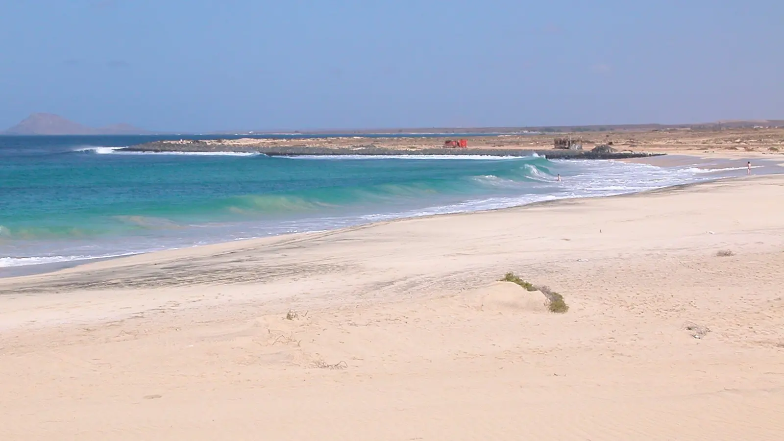 Pale sand and turquoise Atlantic surf at Ponta Preta on Sal