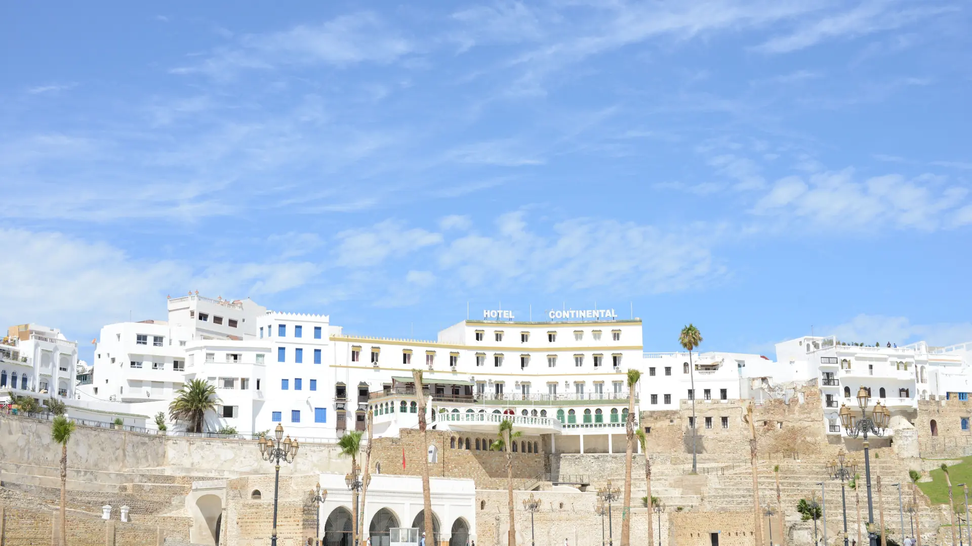 White Hotel Continental above Tangier port walls beneath a blue sky