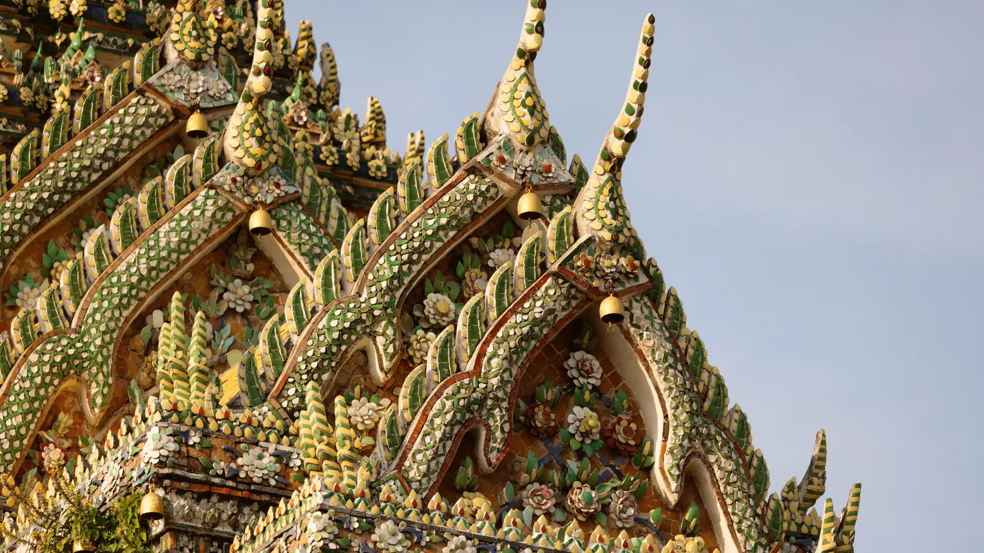 Colourful ceramic roof ornaments at Wat Pho in Bangkok, illustrating the wider city