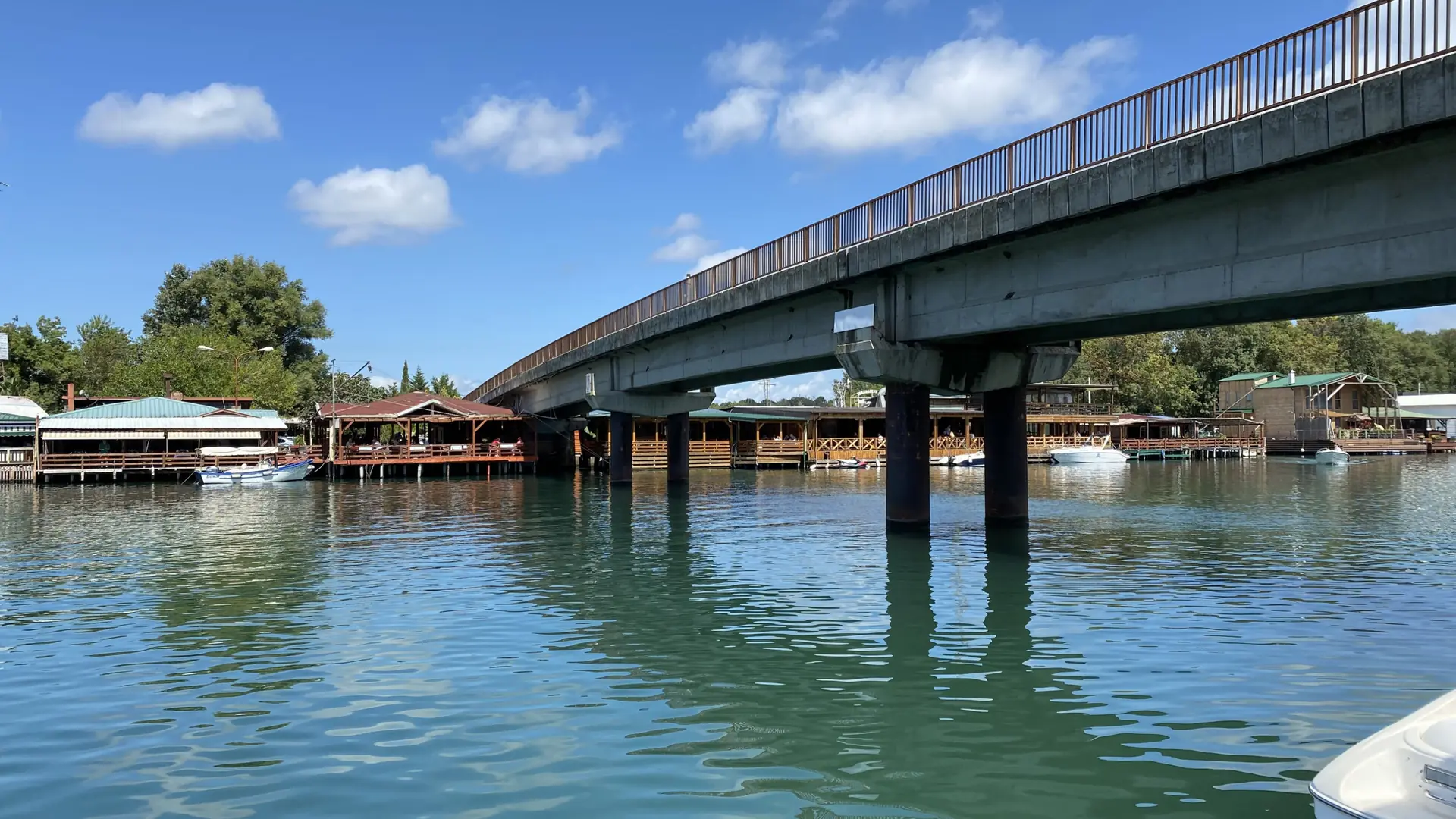 Bridge across the Bojana River to Ada Bojana, beside low waterfront buildings