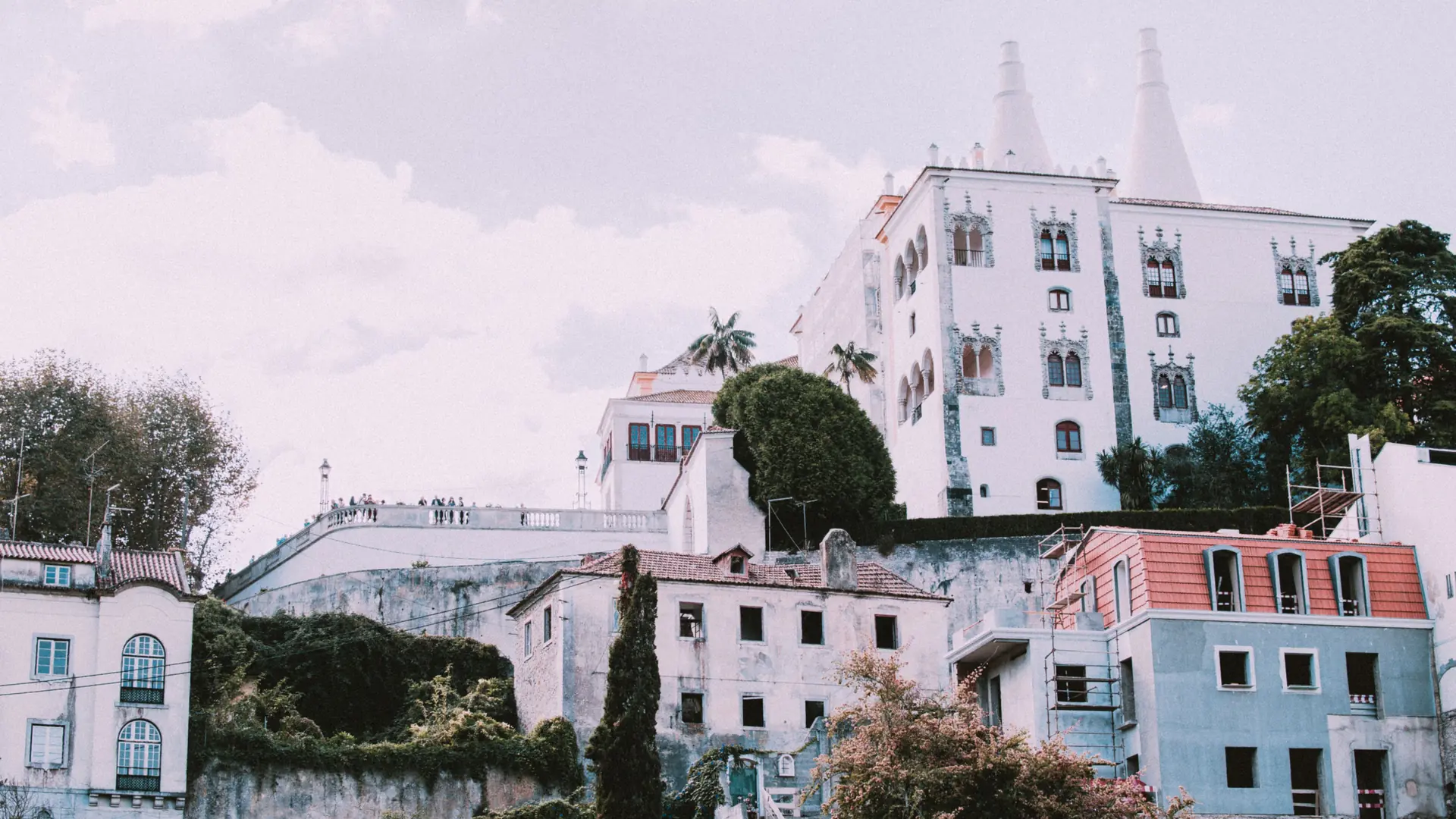 Sintra National Palace and surrounding historic buildings among green trees