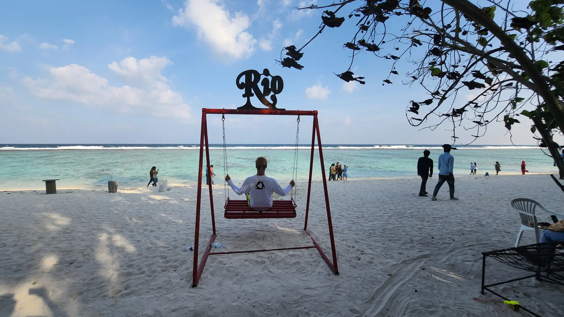 Sunny beach swing on Hulhumalé public shore with the sea behind it