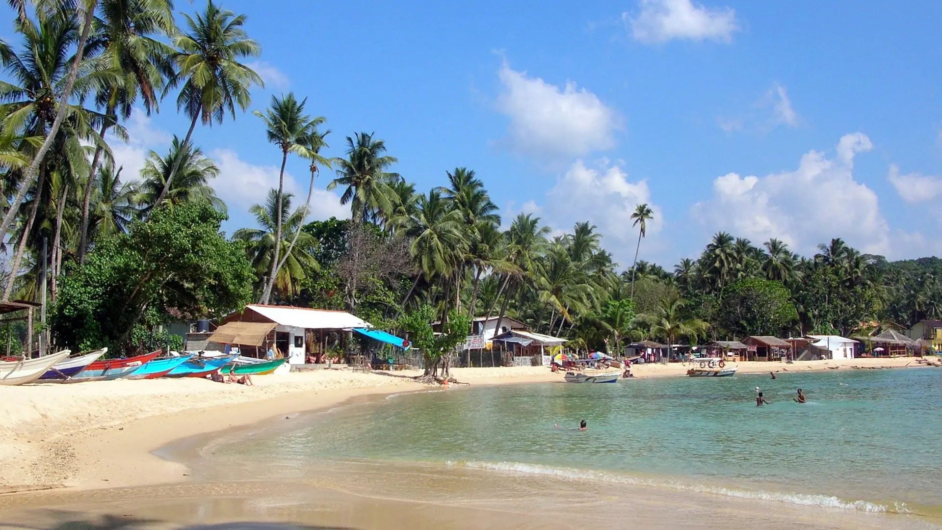 Sunny Unawatuna bay and sandy beachfront near Galle