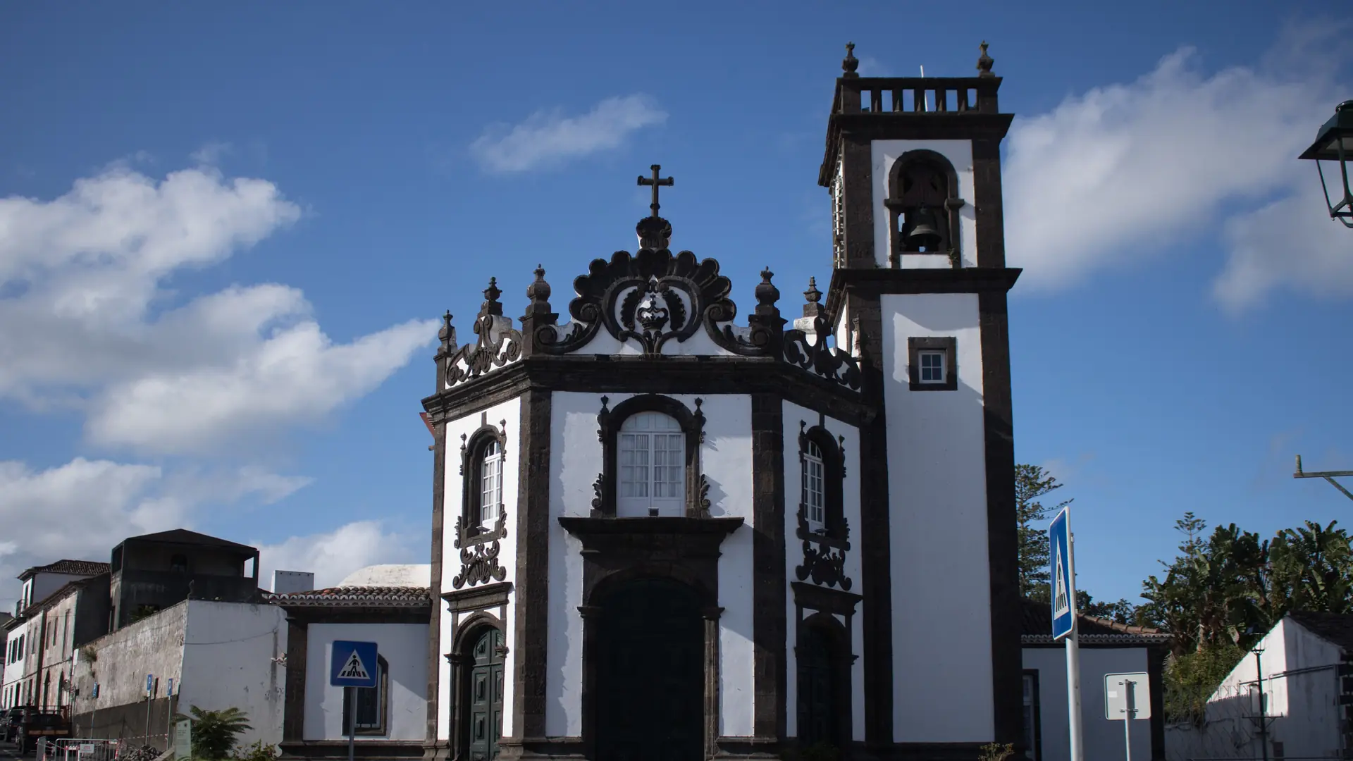 the black-trimmed parish church of Fajã de Baixo under a vivid blue sky in Ponta Delgada