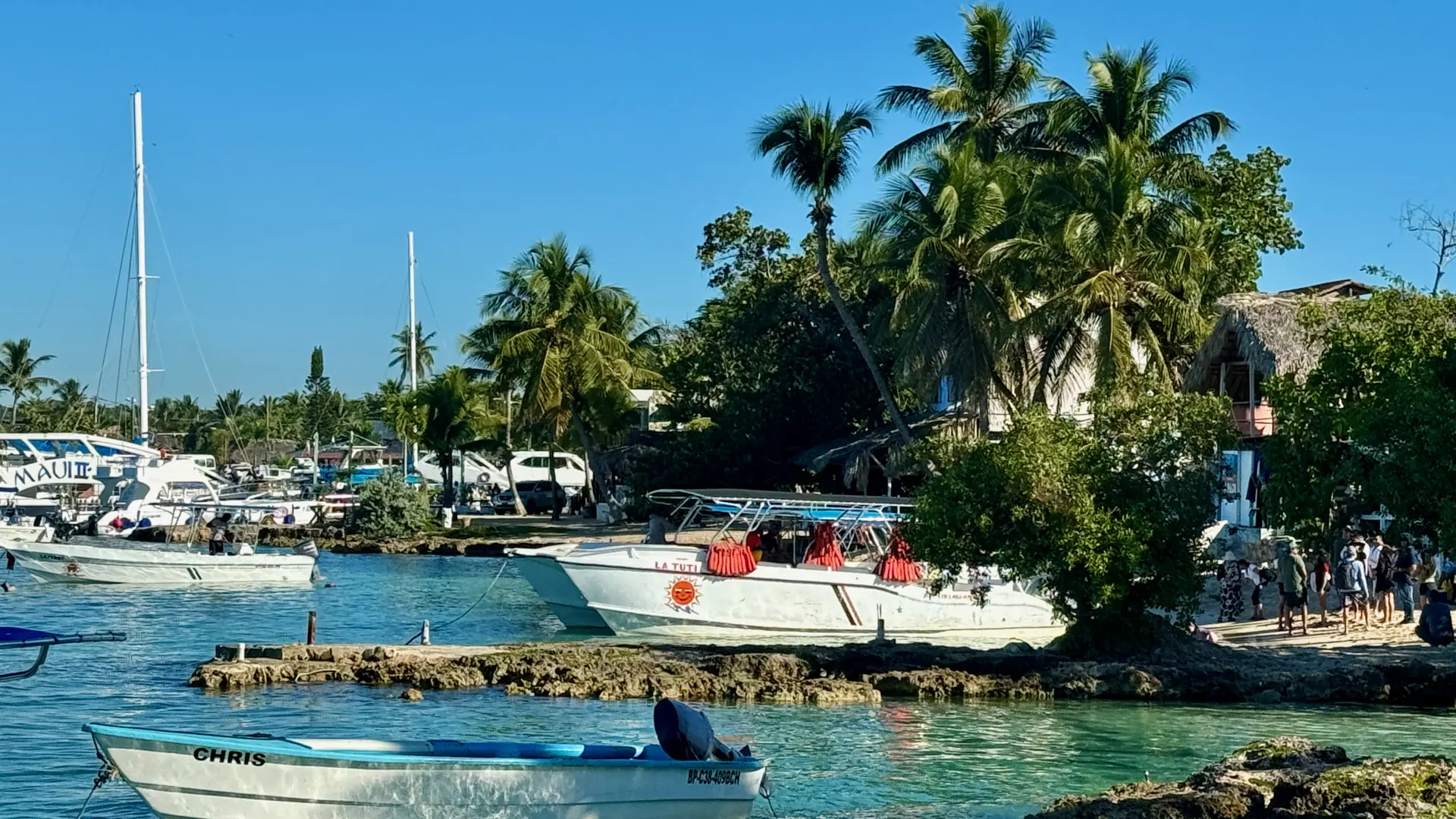 Sunny waterfront and boats at Bayahíbe village