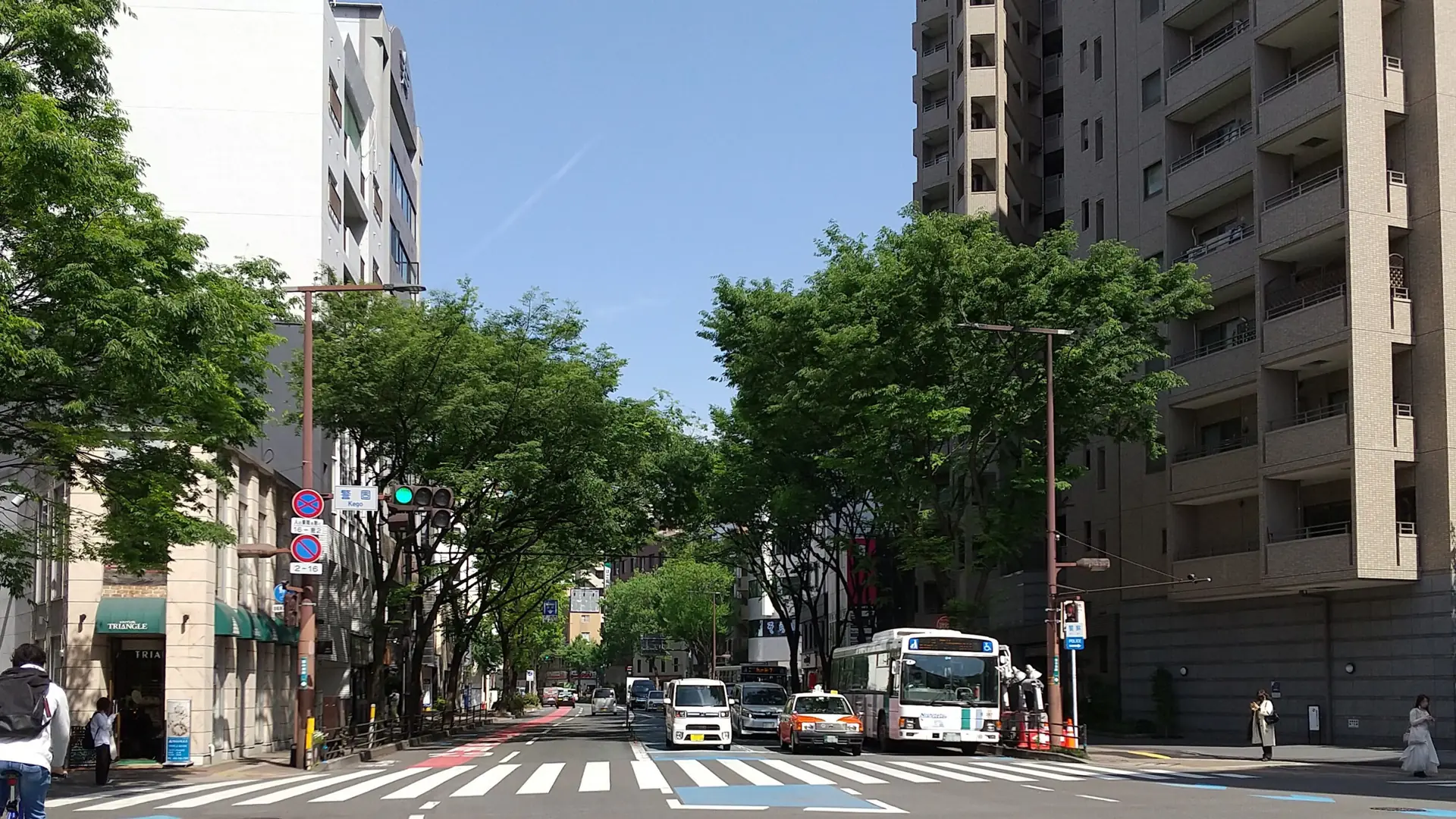 sunny Daimyo side street in Fukuoka lined with colourful boutiques and cafés