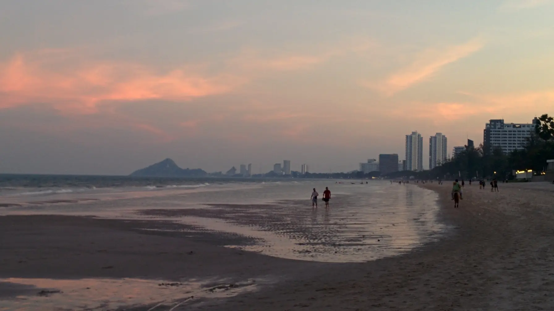 Warm evening light settling over Hua Hin Beach and the distant coast