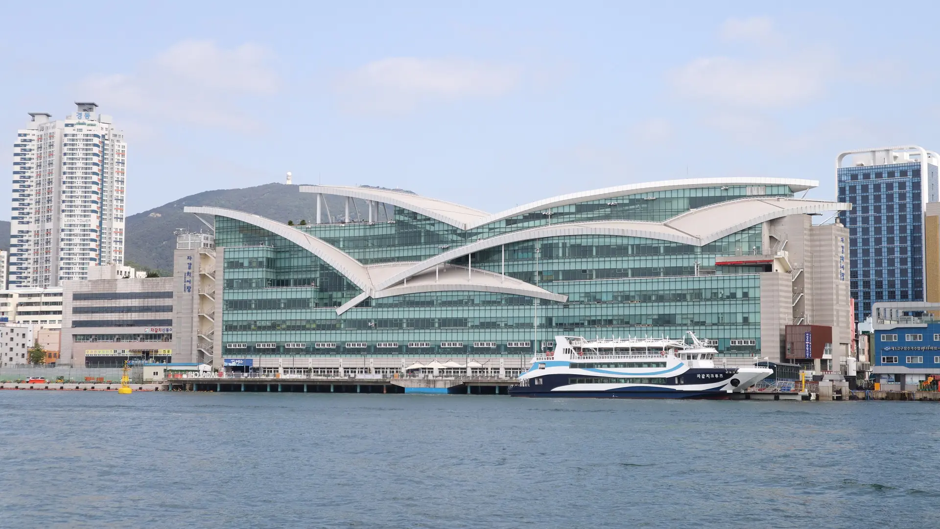 Jagalchi Market’s glass waterfront facade and white gull-shaped roof in Busan