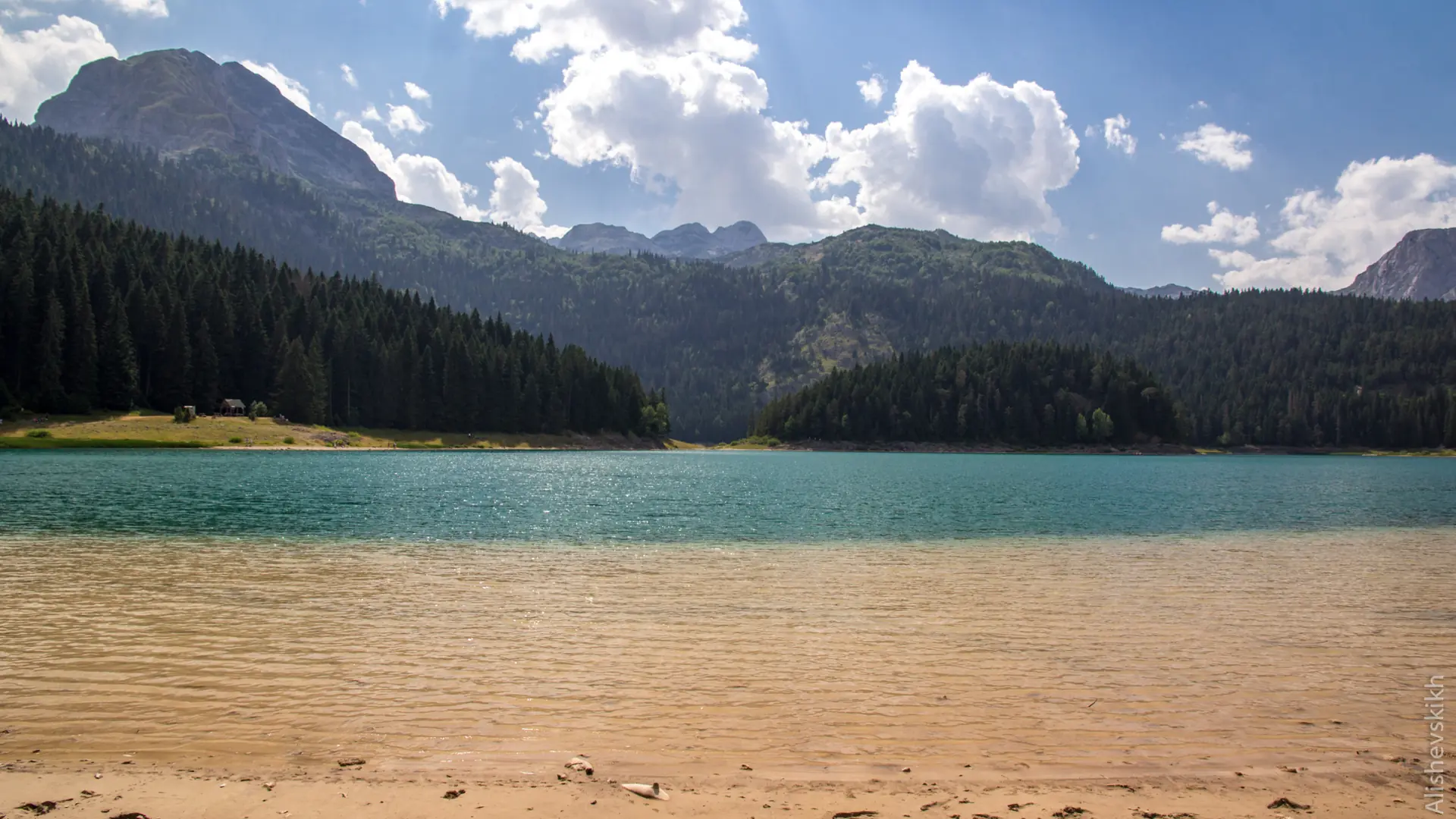 Green Durmitor mountains and Black Lake near Žabljak in bright daylight