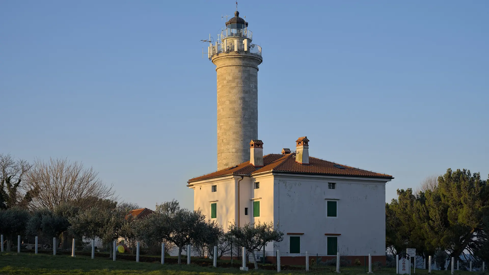 Savudrija lighthouse and its adjoining building in morning sunlight
