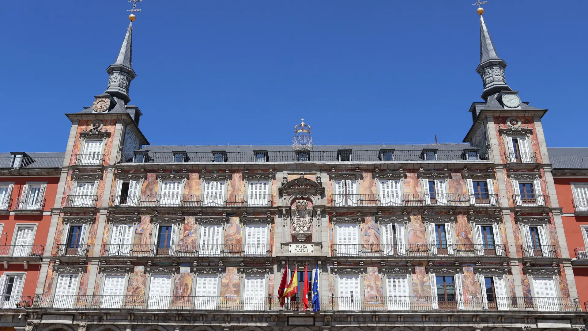 Casa de la Panadería with murals and flags in Madrid’s Plaza Mayor