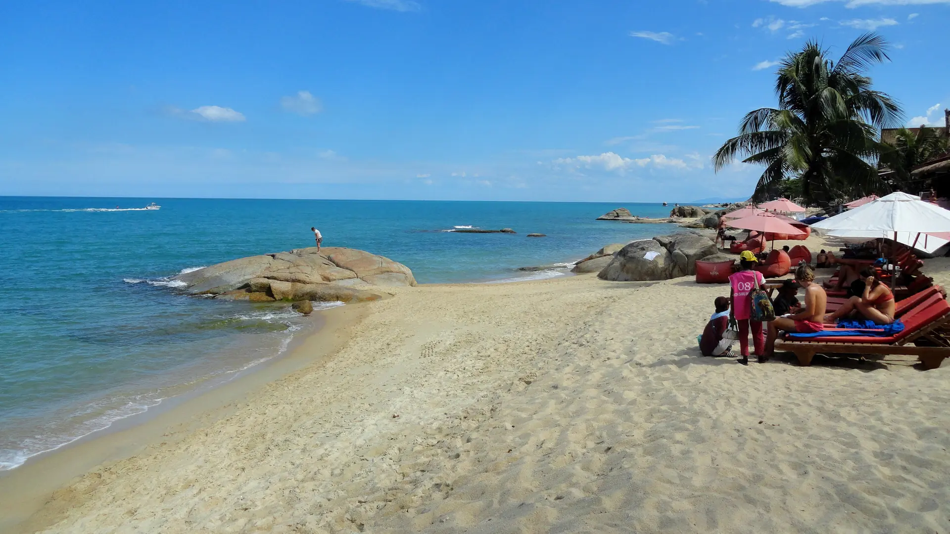 Sunny granite rocks and beach umbrellas at Lamai in wider Koh Samui, rather than Bophut