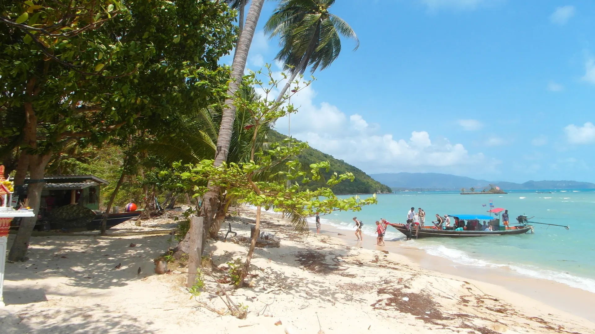 A small boat crossing clear water off the Koh Samui archipelago
