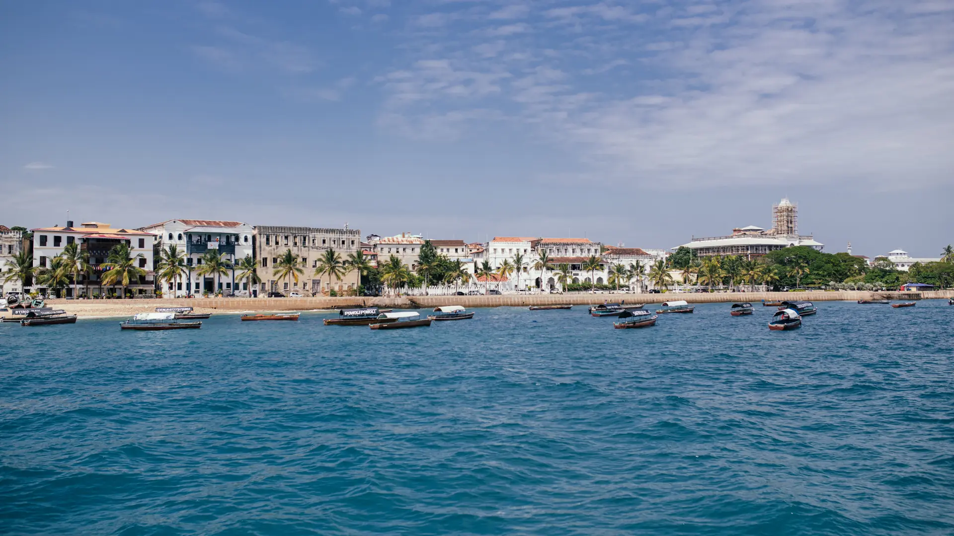 Stone Town waterfront and historic buildings under a bright sky