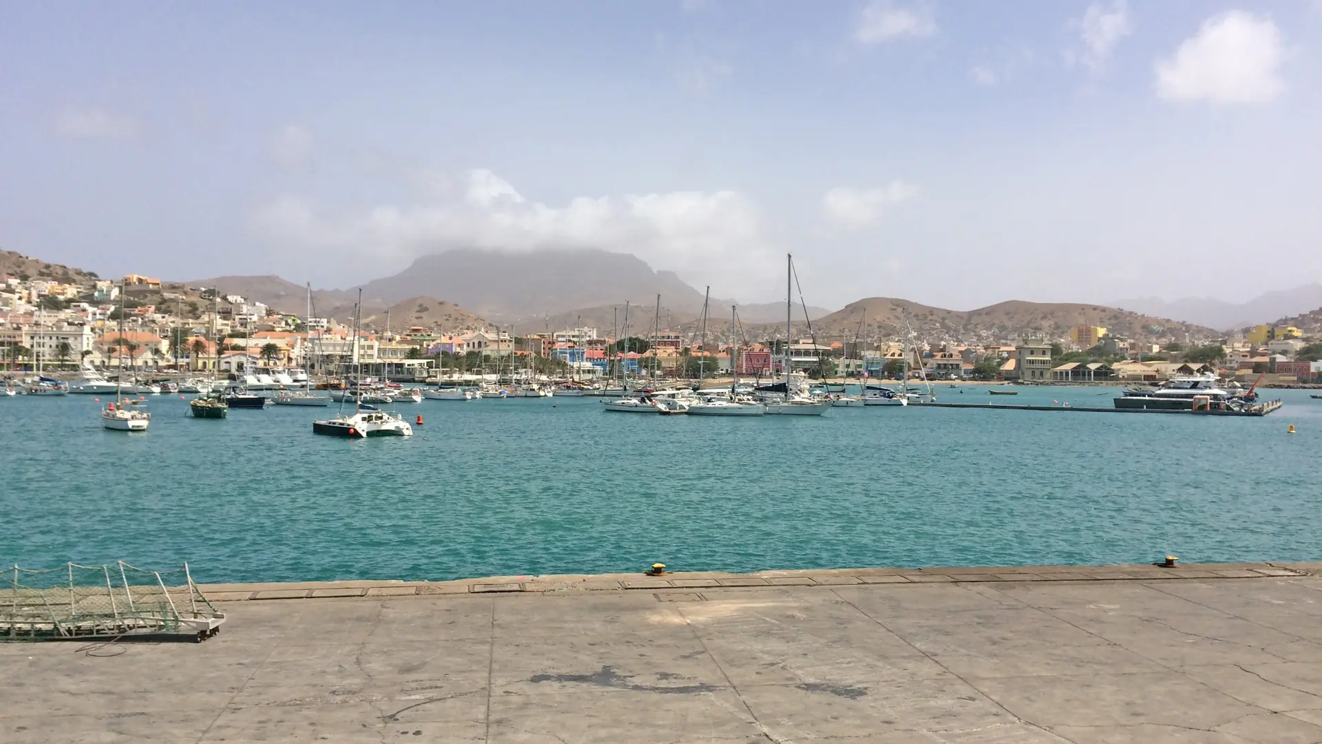 Sunny Mindelo harbour with boats and São Vicente hills
