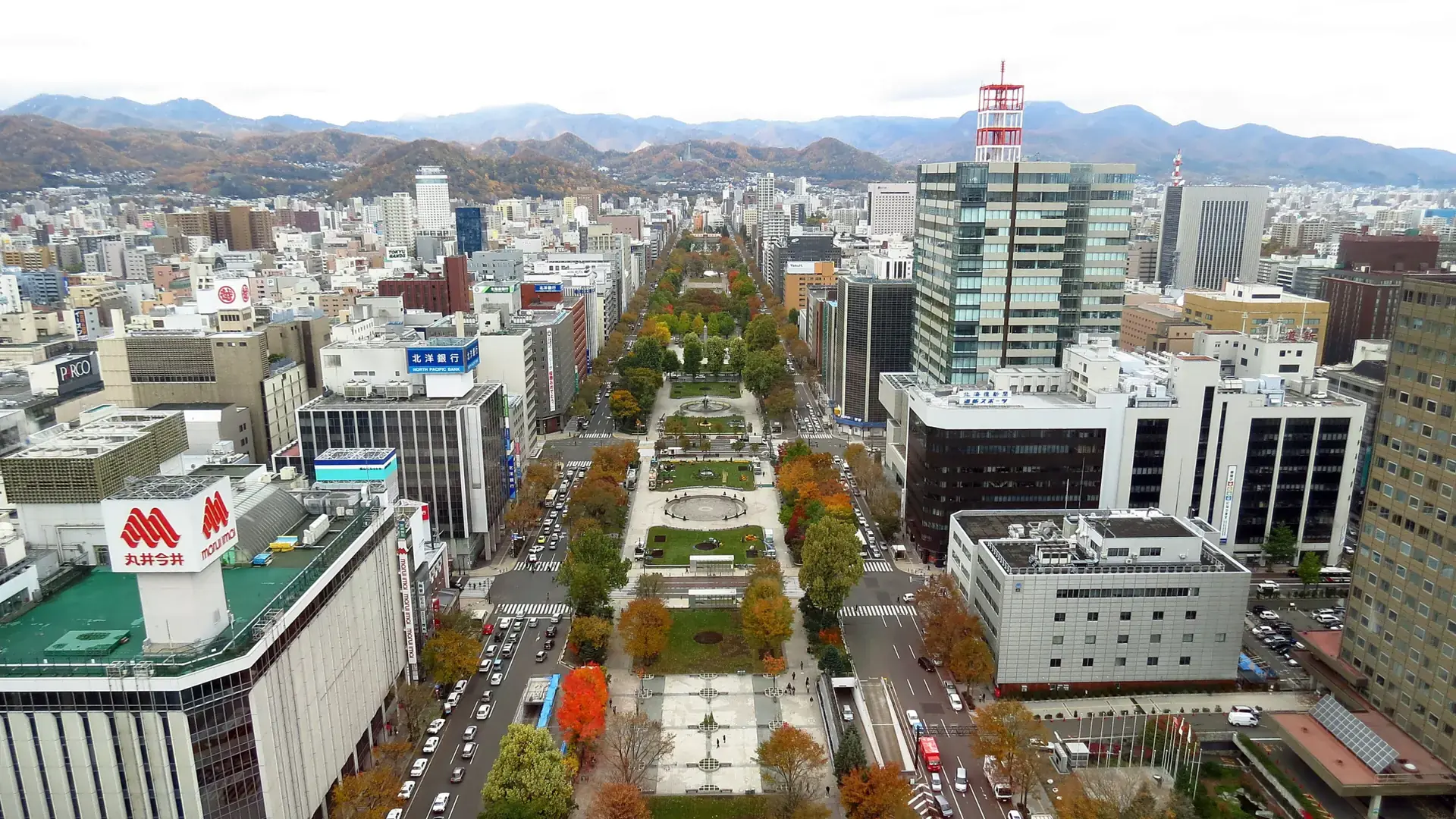 aerial view along Odori Park through central Sapporo toward the mountains