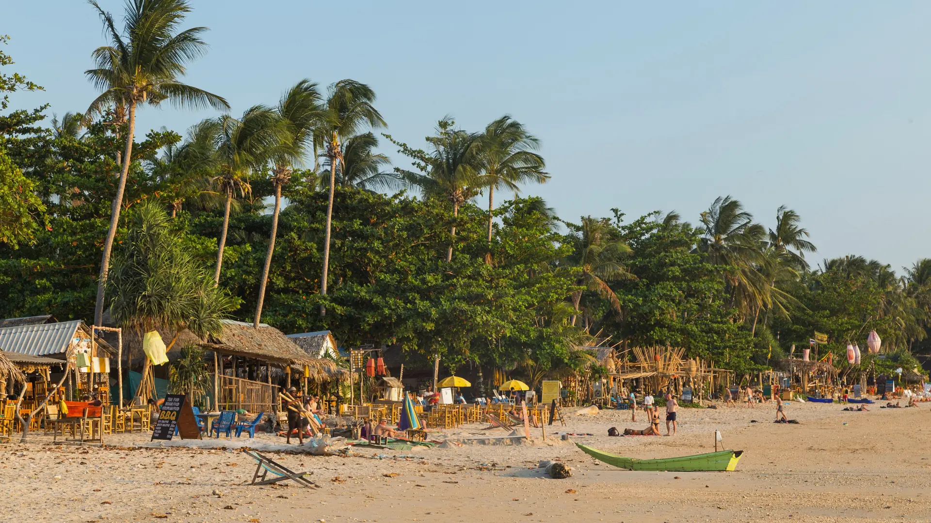 A long open sweep of sand and turquoise water on Koh Lanta