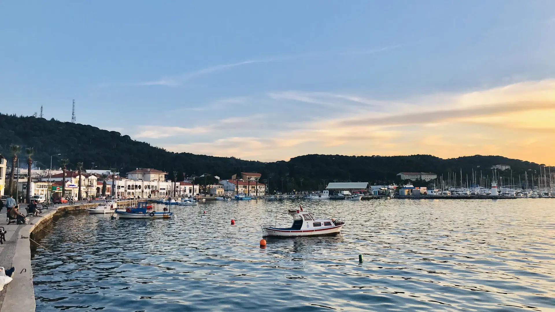 Small boats on the Cunda waterfront at sunset near Ayvalık