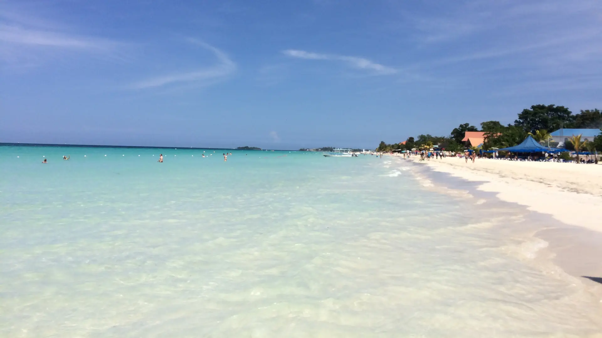 The sandy coastline and clear sea at Negril in Jamaica