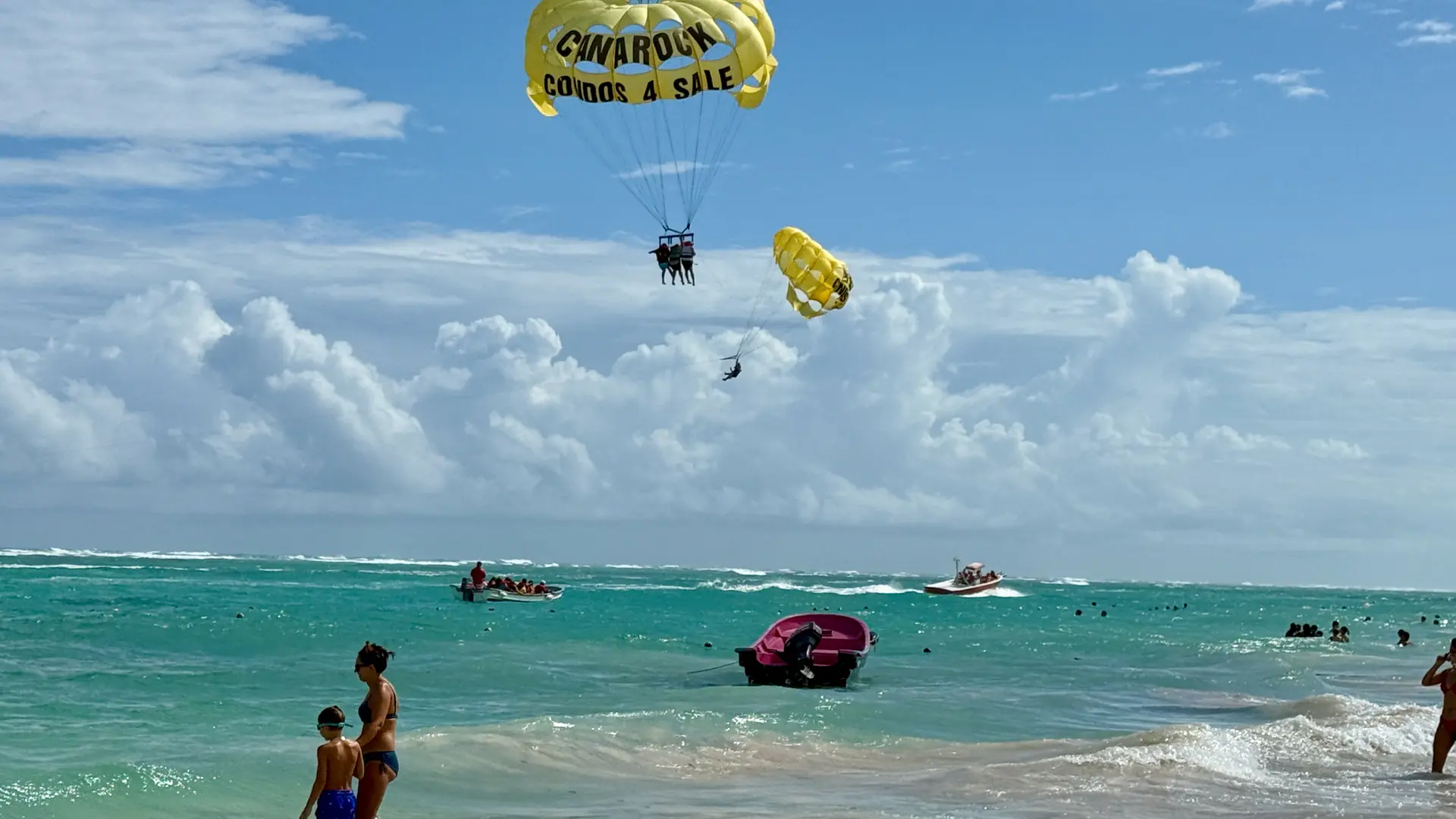 Parasailing above sunny Bávaro beach and turquoise water