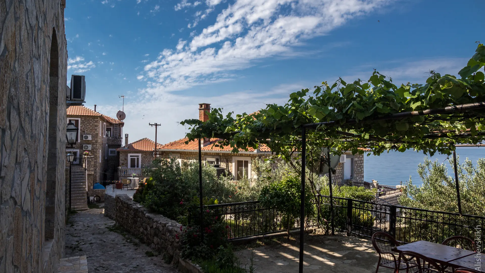 Sunlit stone lane and shaded terrace above the sea in Ulcinj Old Town