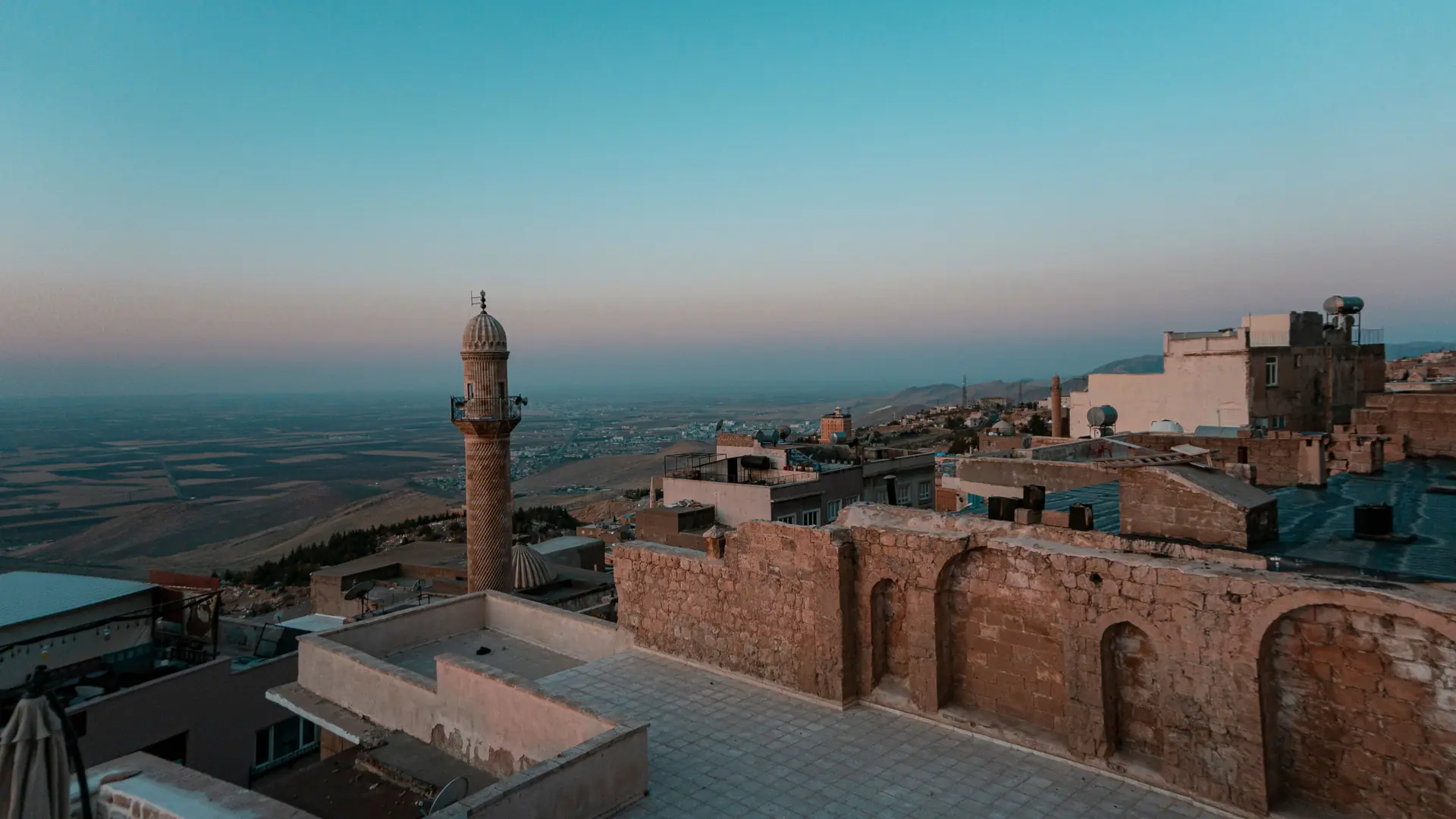 Mardin stone houses and minarets above the Mesopotamian plain at dawn