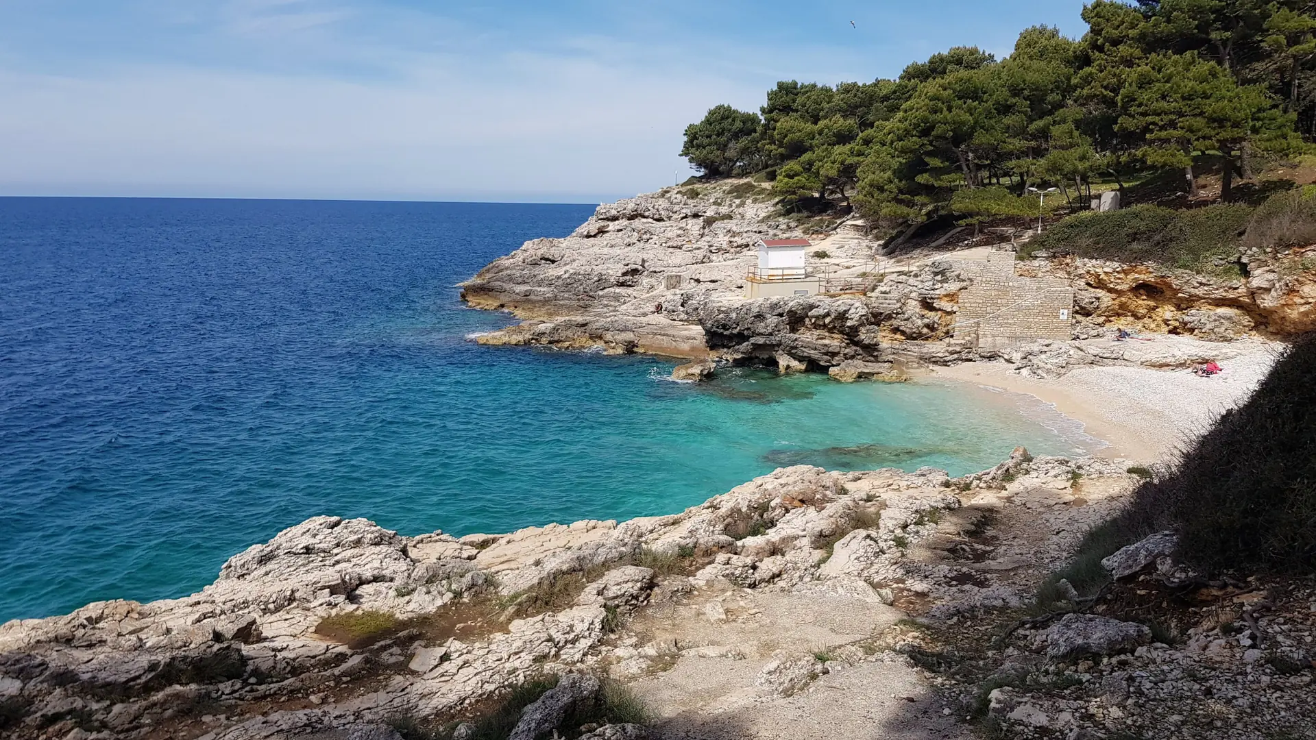 Hawaii Beach at Verudela in Pula, with pale rocks, pines and turquoise water