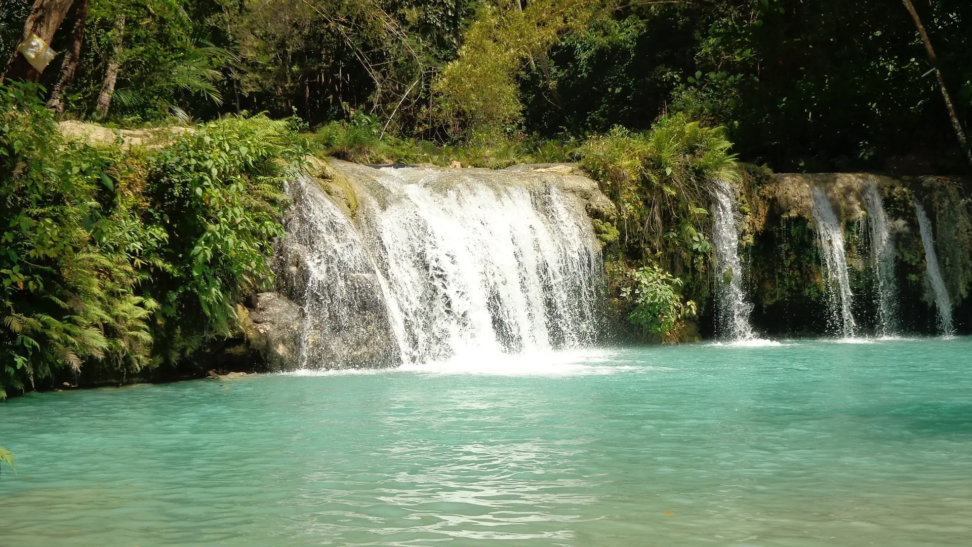 Turquoise pools and small cascades at Cambugahay Falls in Lazi, Siquijor