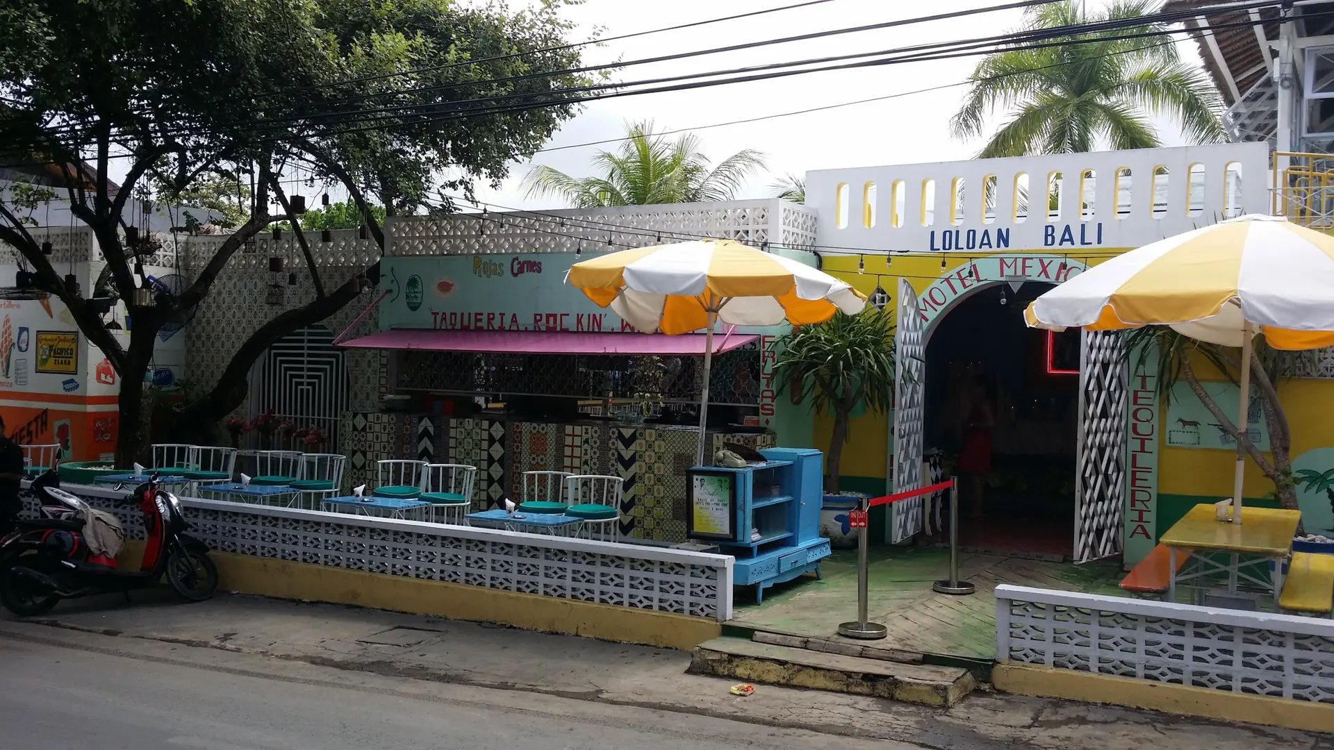 Yellow-and-white umbrellas outside the Mexican Motel café in Seminyak, photographed in 2014
