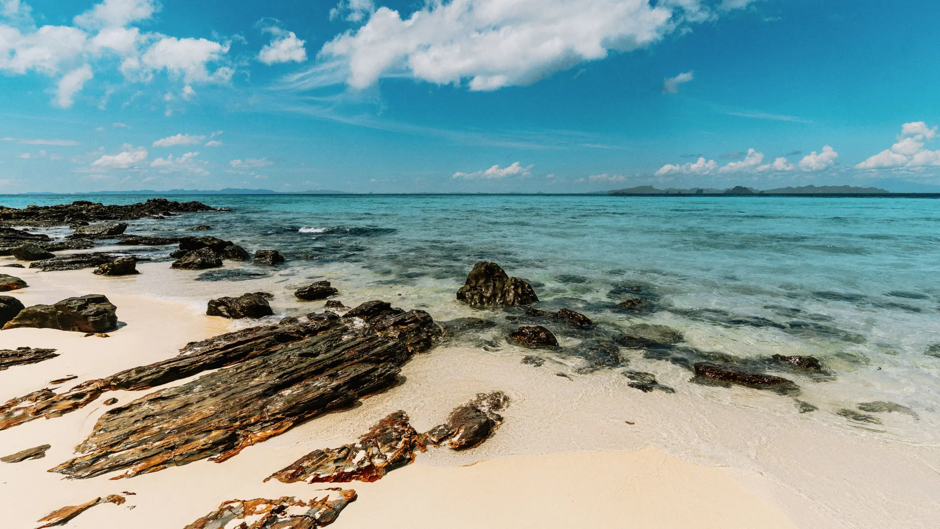 Calm turquoise water and a quiet sandy beach near Krabi