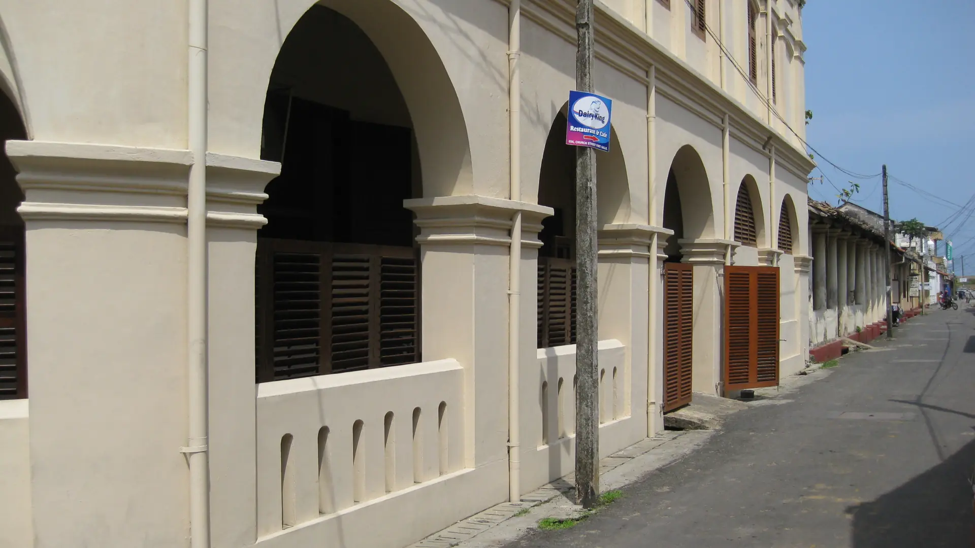 Sunlit Dutch-era colonnades on a street inside Galle Fort