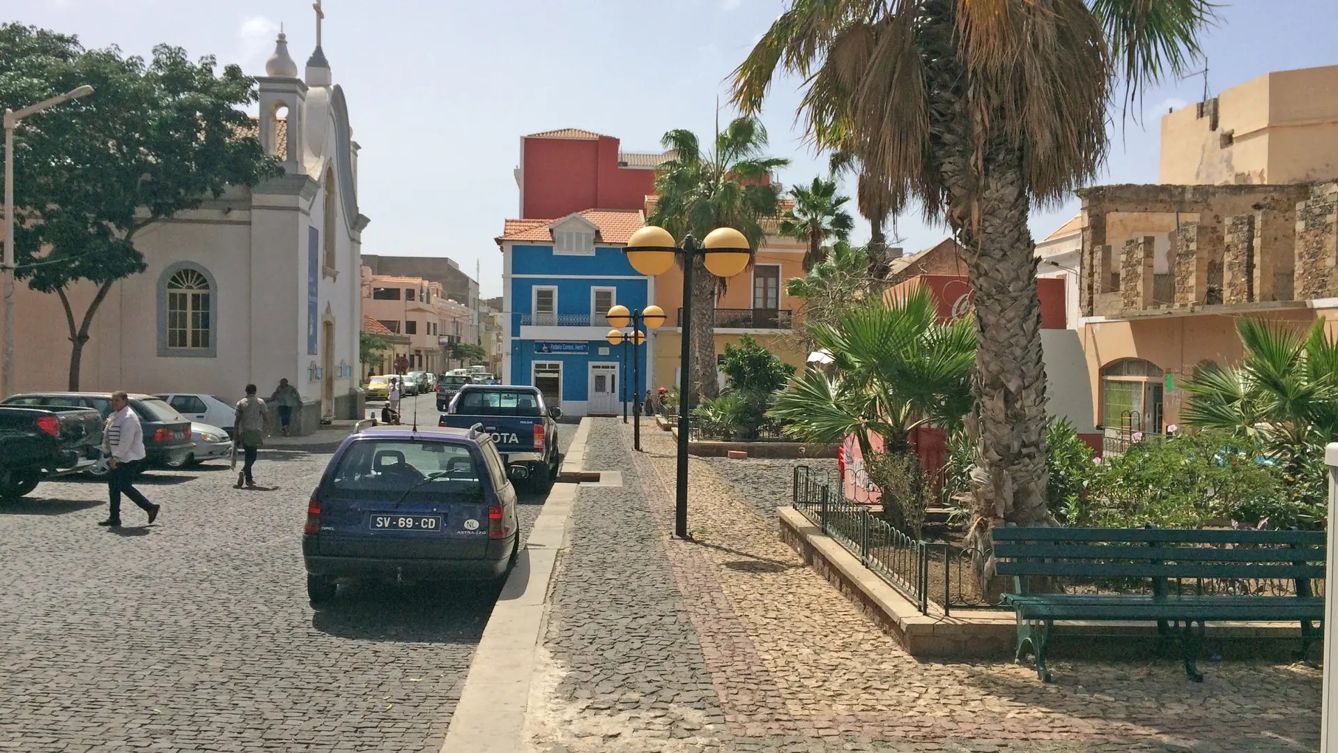 Sunny Rua da Luz with Nossa Senhora da Luz church and palms in Mindelo