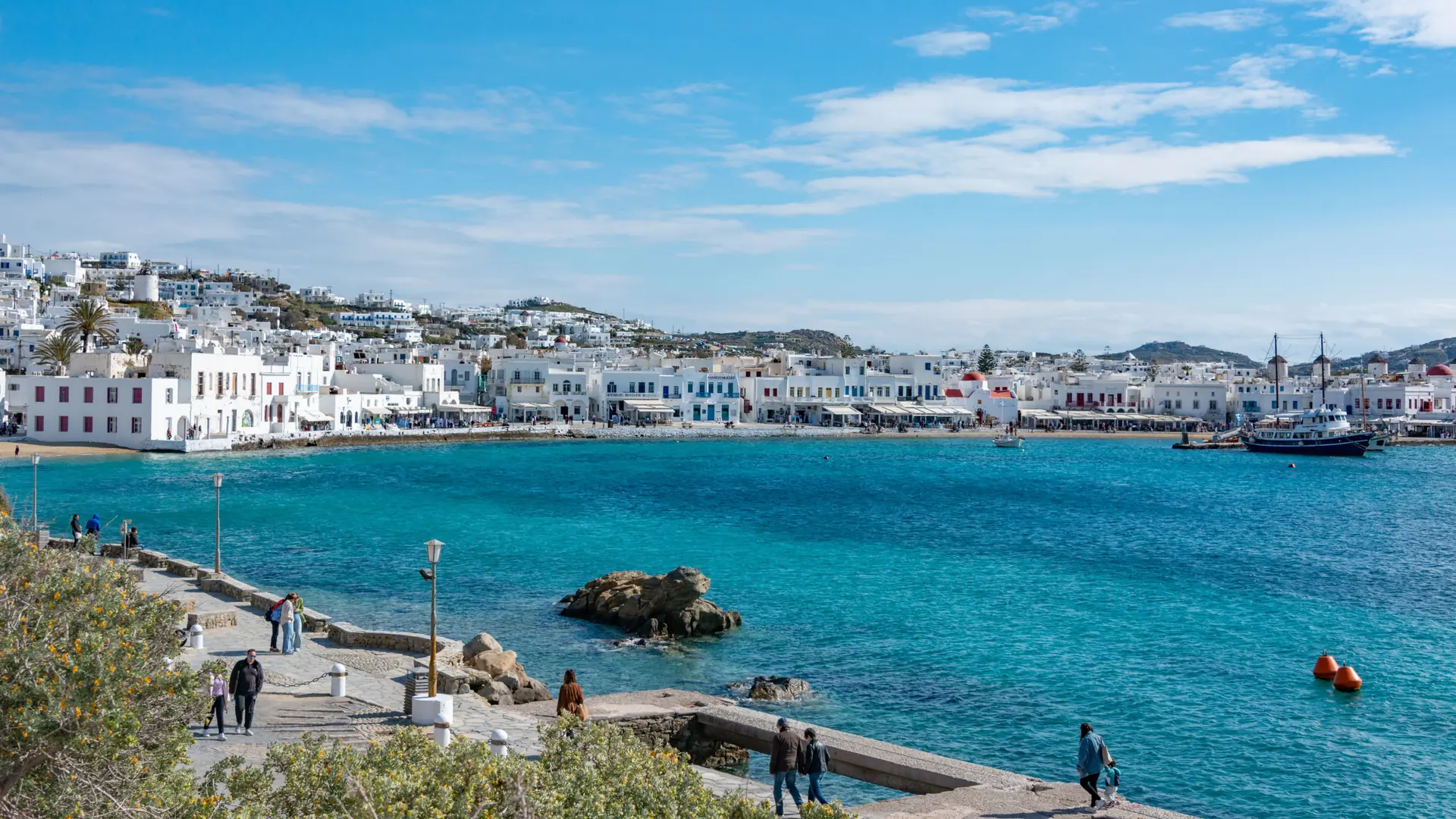 Mykonos Town’s Old Port waterfront and blue Aegean water in bright daylight