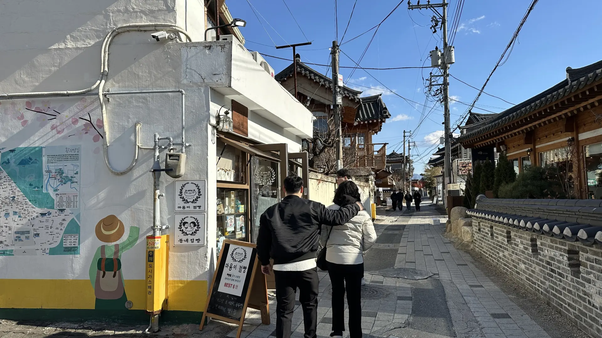 A sunny Hwangnidan-gil alley lined with hanok-style shops in Gyeongju's old town