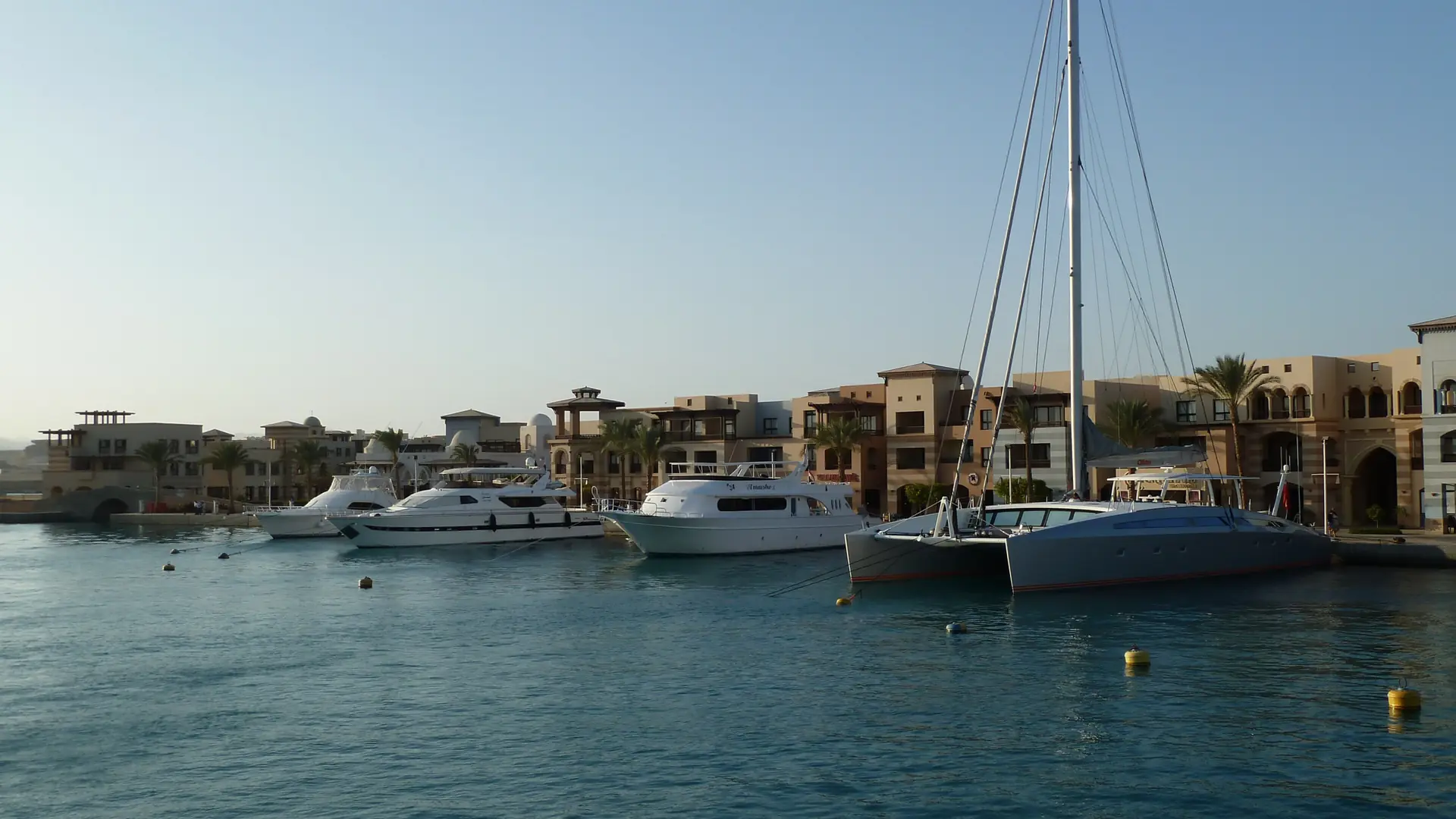 Sunlit Port Ghalib marina and waterfront