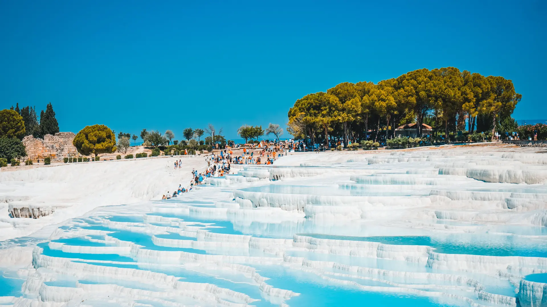 Bright white travertine terraces and turquoise pools at Pamukkale