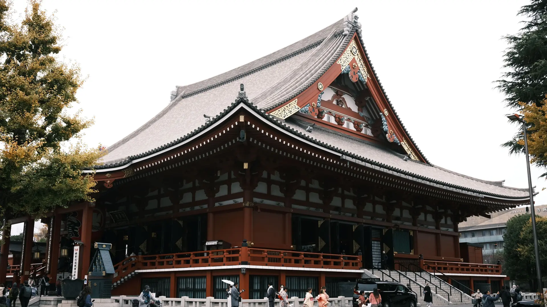 Ueno Park temple architecture, trees and visitors in clear spring daylight
