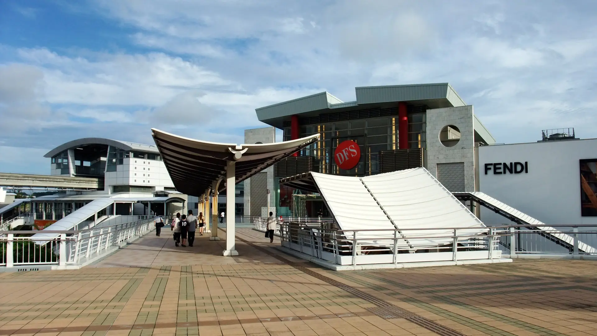 sunny Omoromachi Station plaza and modern shopping buildings in Naha