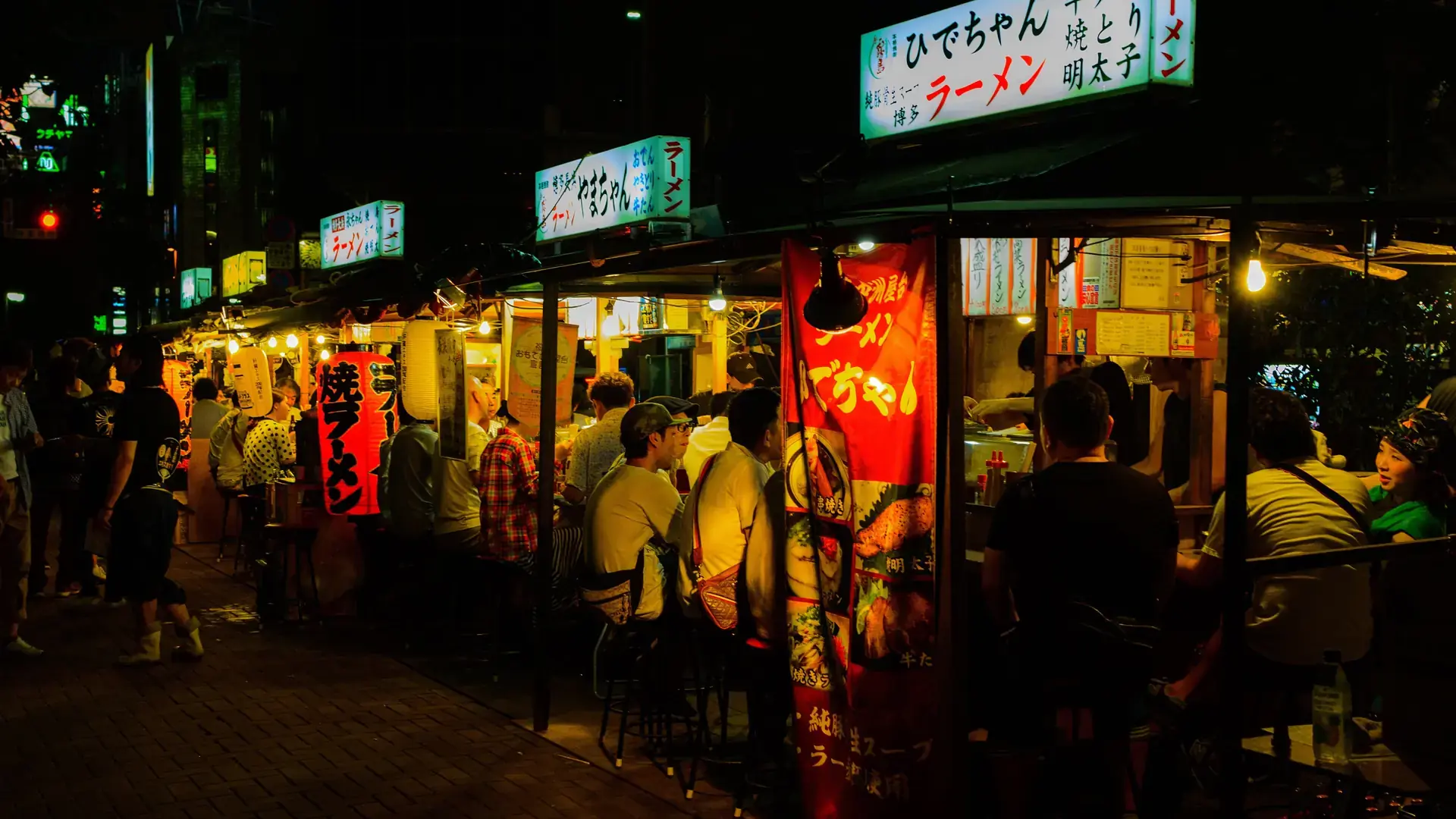vivid lantern-lit Hakata yatai stalls serving diners near Nakasu after dark