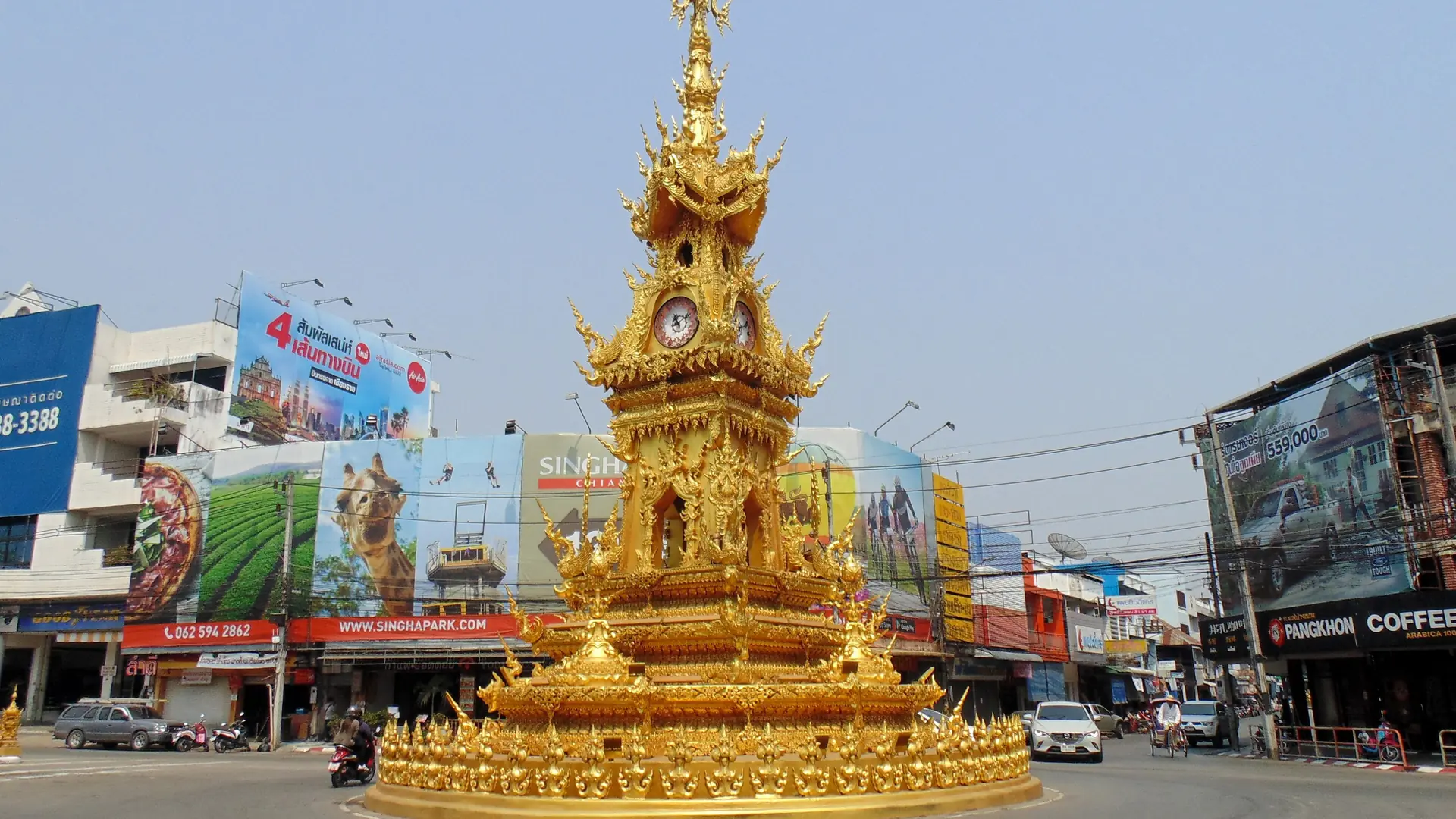 Chiang Rai's golden Clock Tower at its city-centre roundabout in daylight
