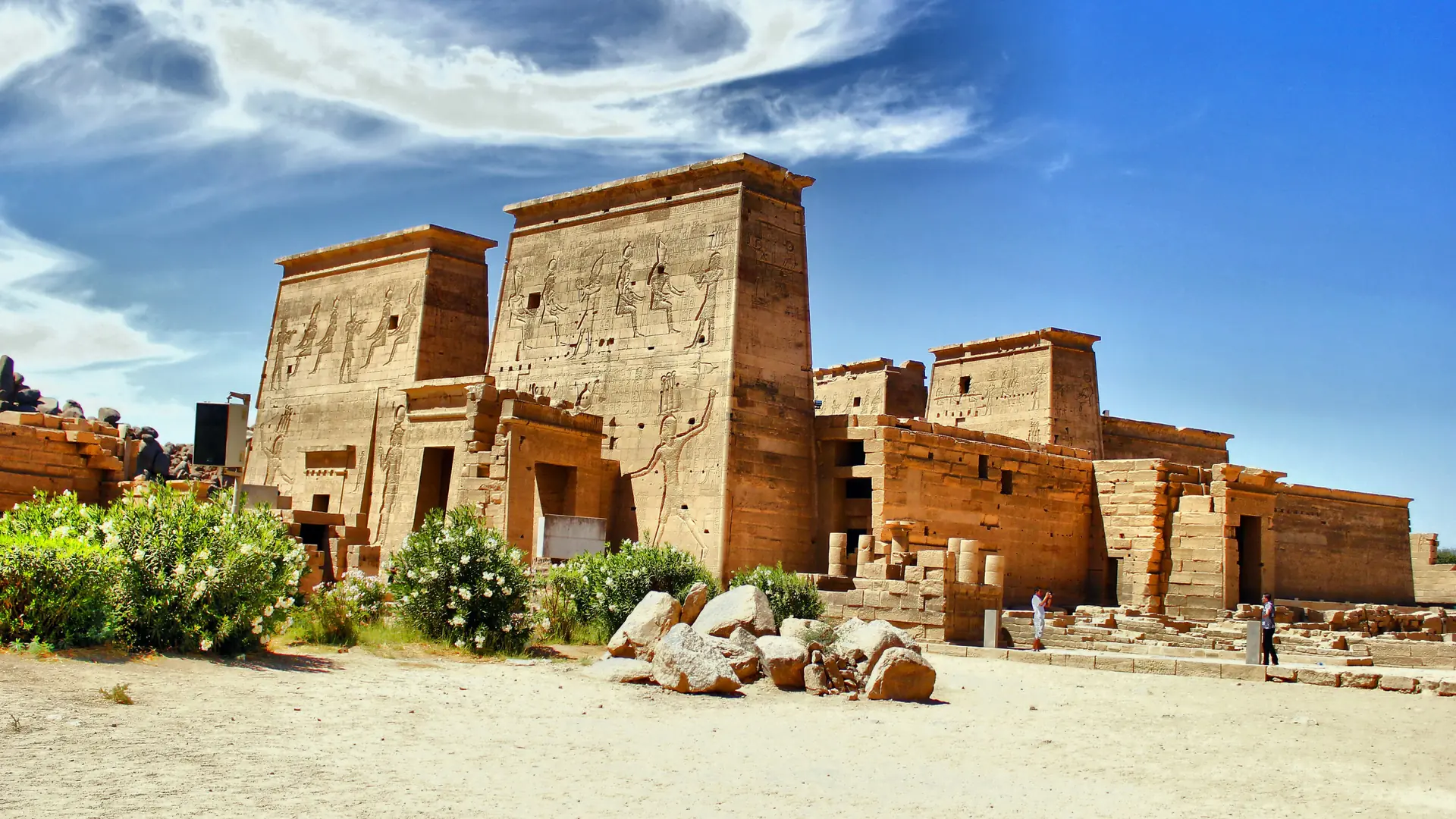 Sunlit pylons of Isis Temple at Philae under blue sky