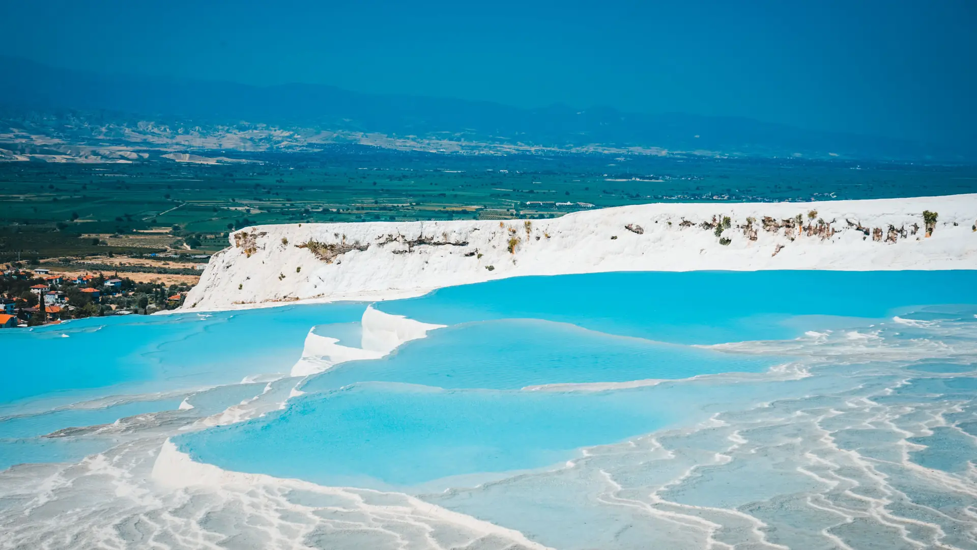 Turquoise water filling the white travertine pools of Pamukkale