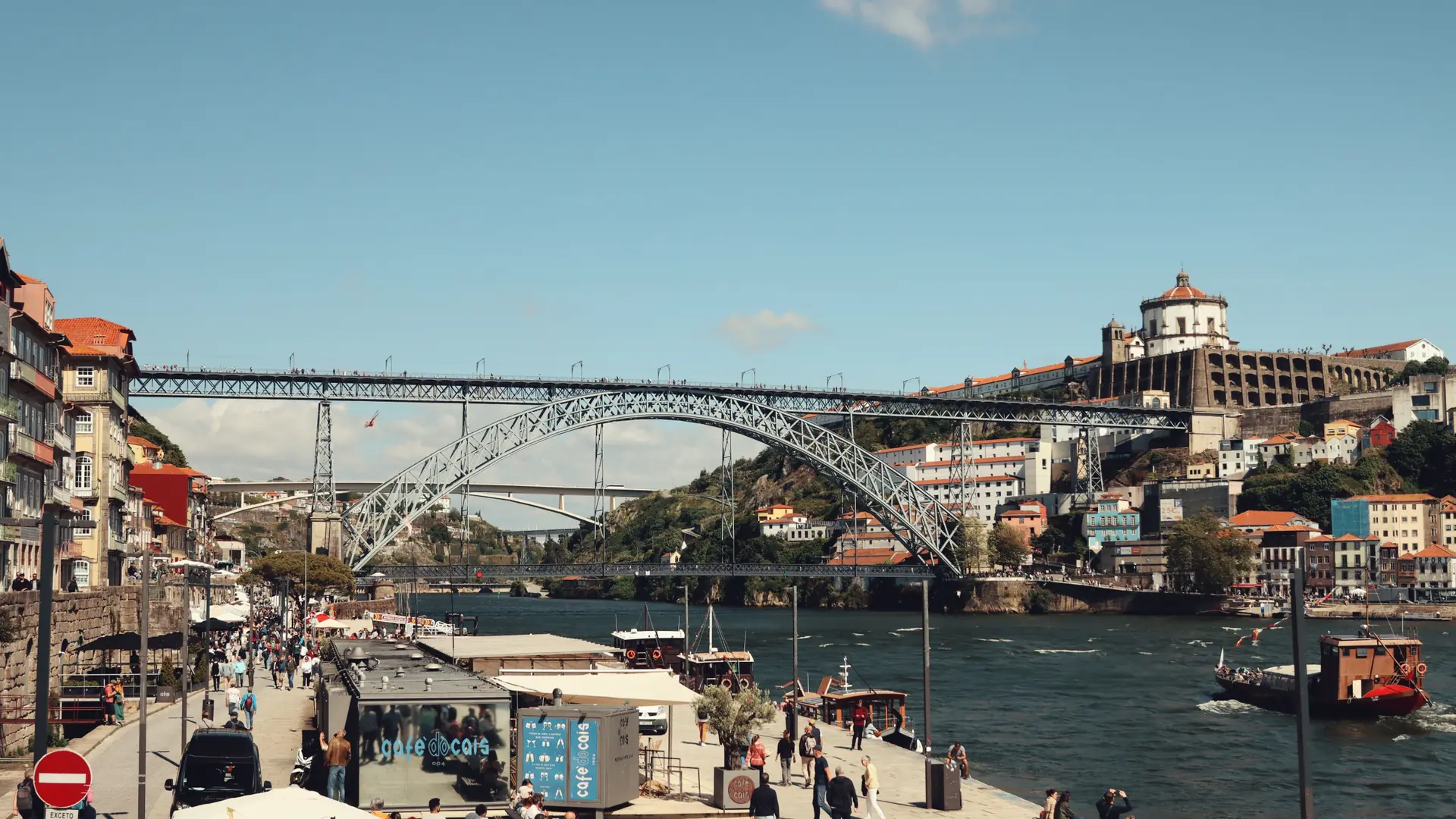 Porto's Ribeira waterfront and Dom Luís I Bridge above boats on the Douro