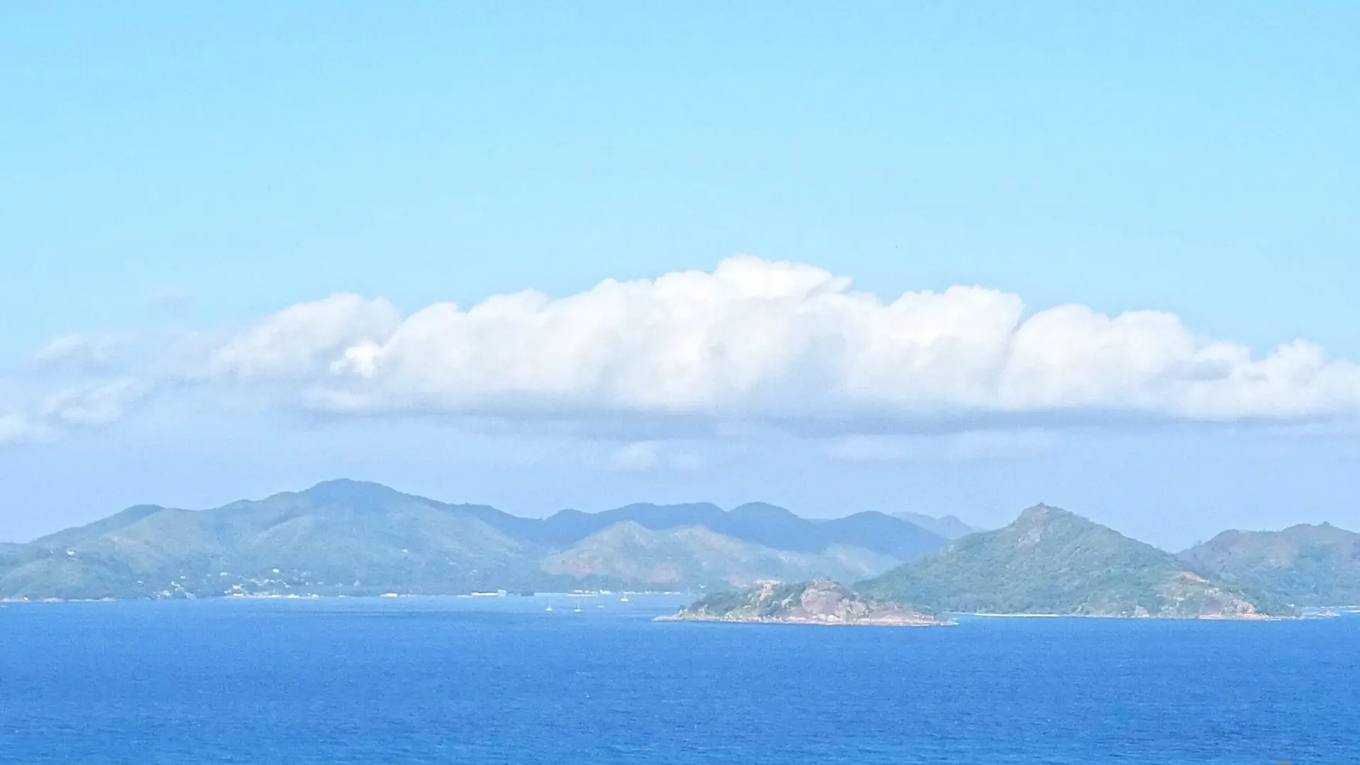East Praslin coastline seen from La Digue; Anse La Blague is not individually identified