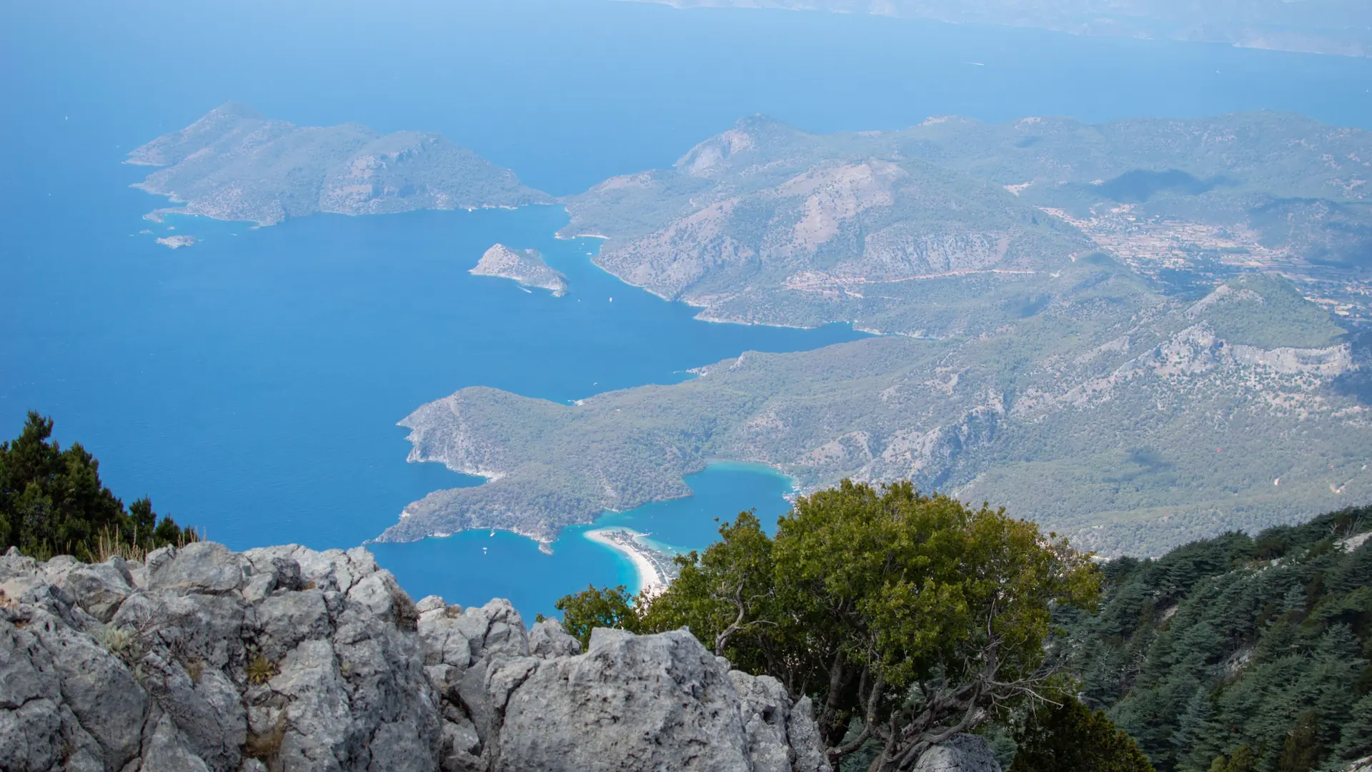 Ölüdeniz lagoon and wooded coastal headlands seen from sunny Babadağ
