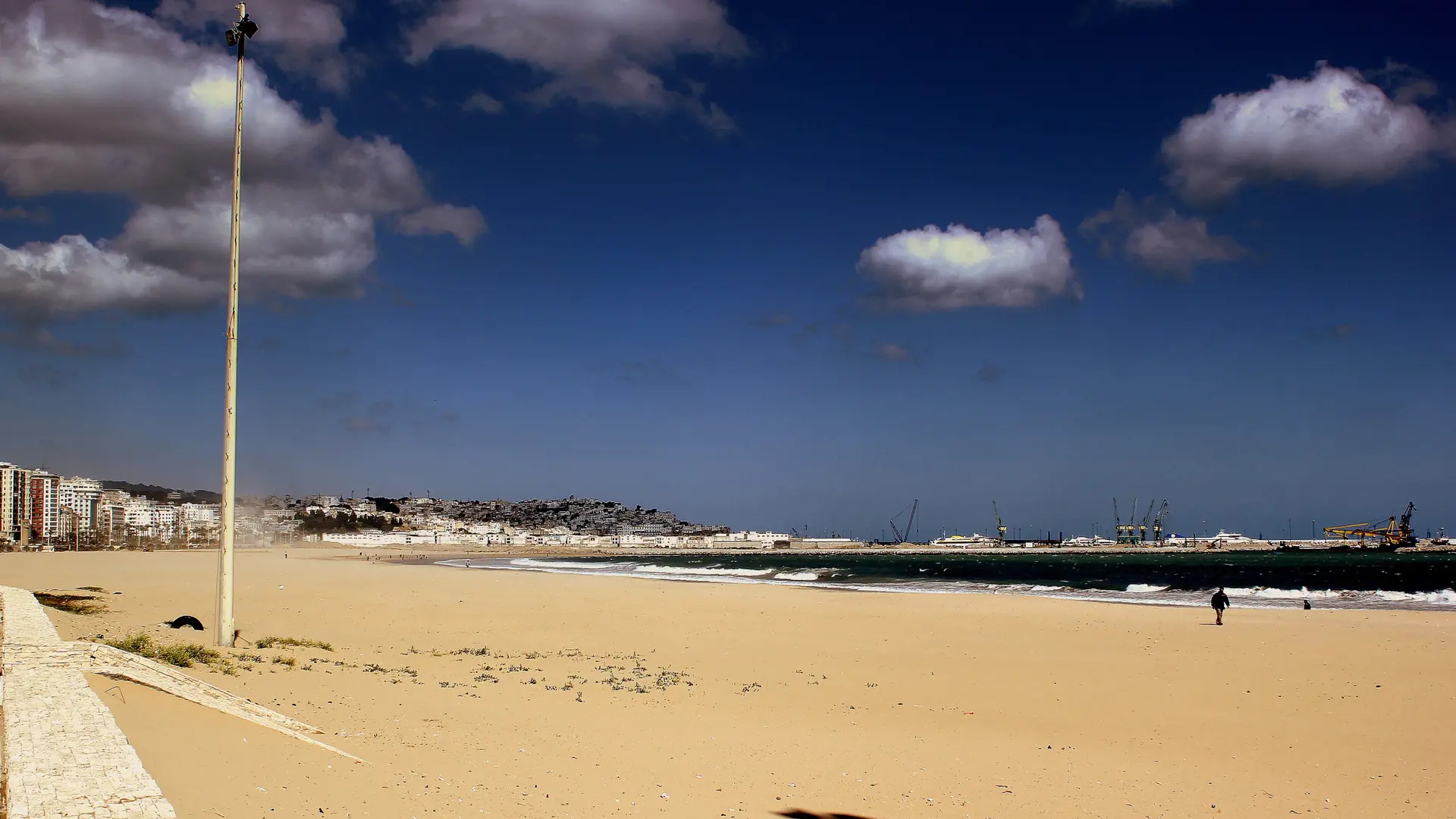 Sandy Tangier city beach beneath a bright blue sky
