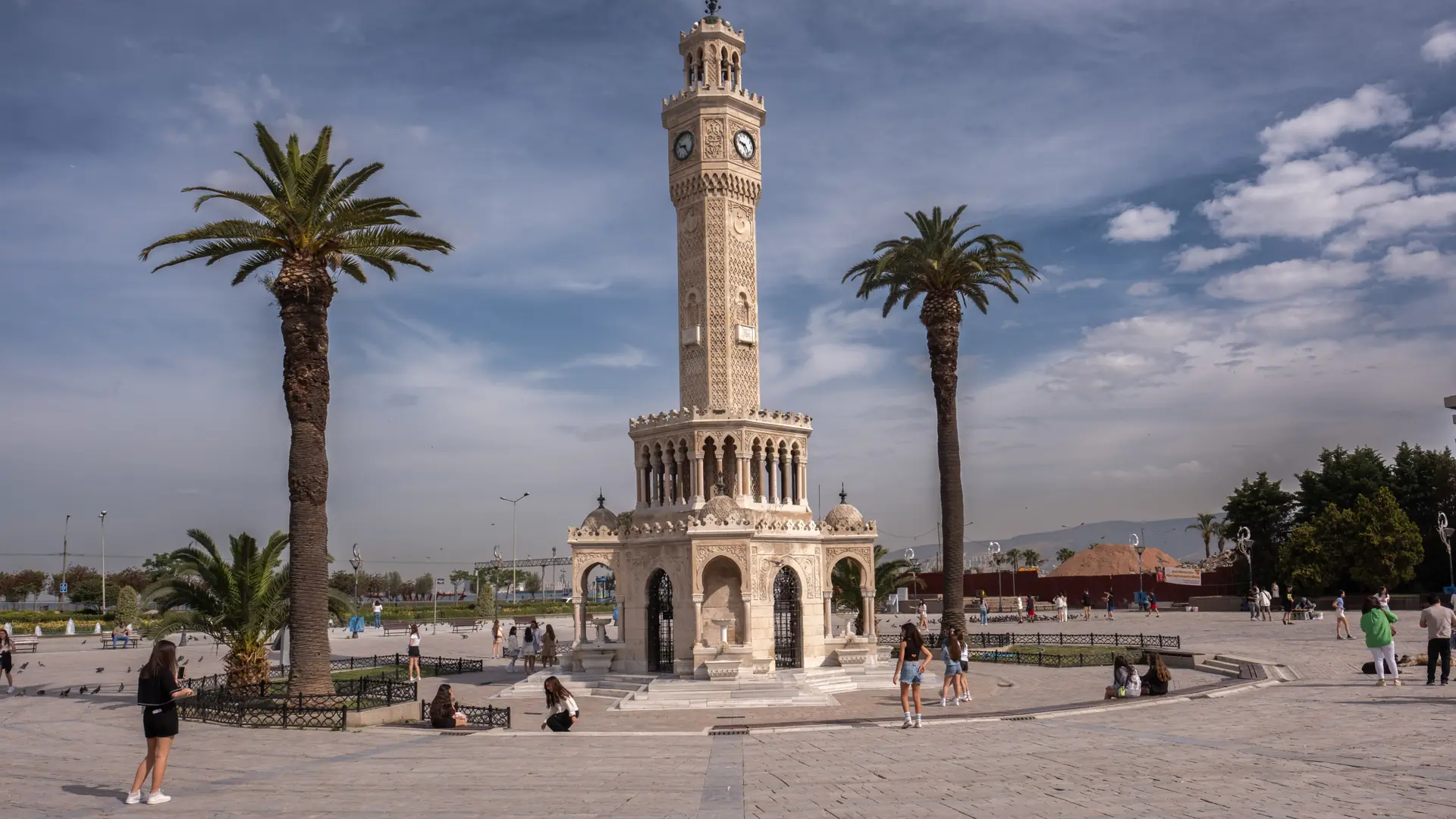 İzmir Clock Tower and Konak waterfront beside the sunlit blue Aegean Bay