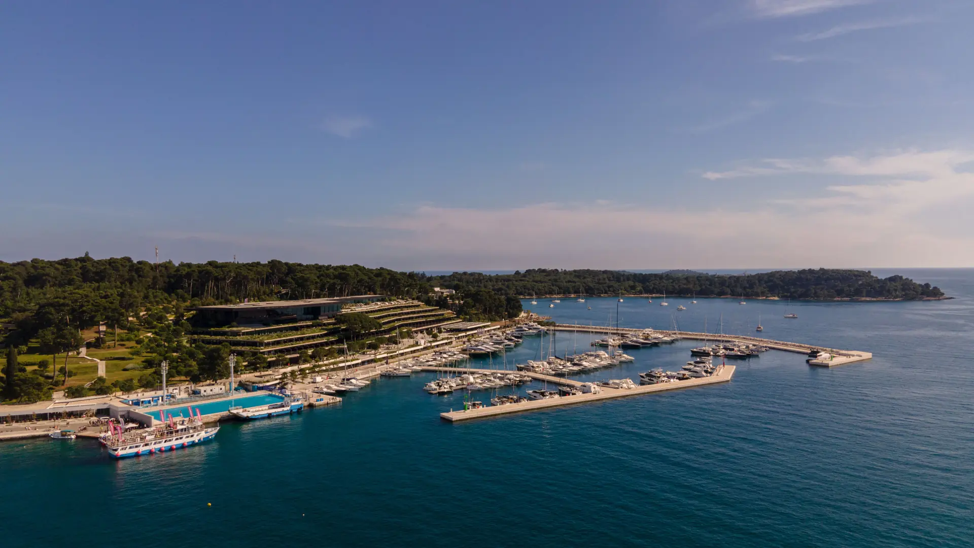 Rovinj marina with yachts beside the terraced waterfront hotel