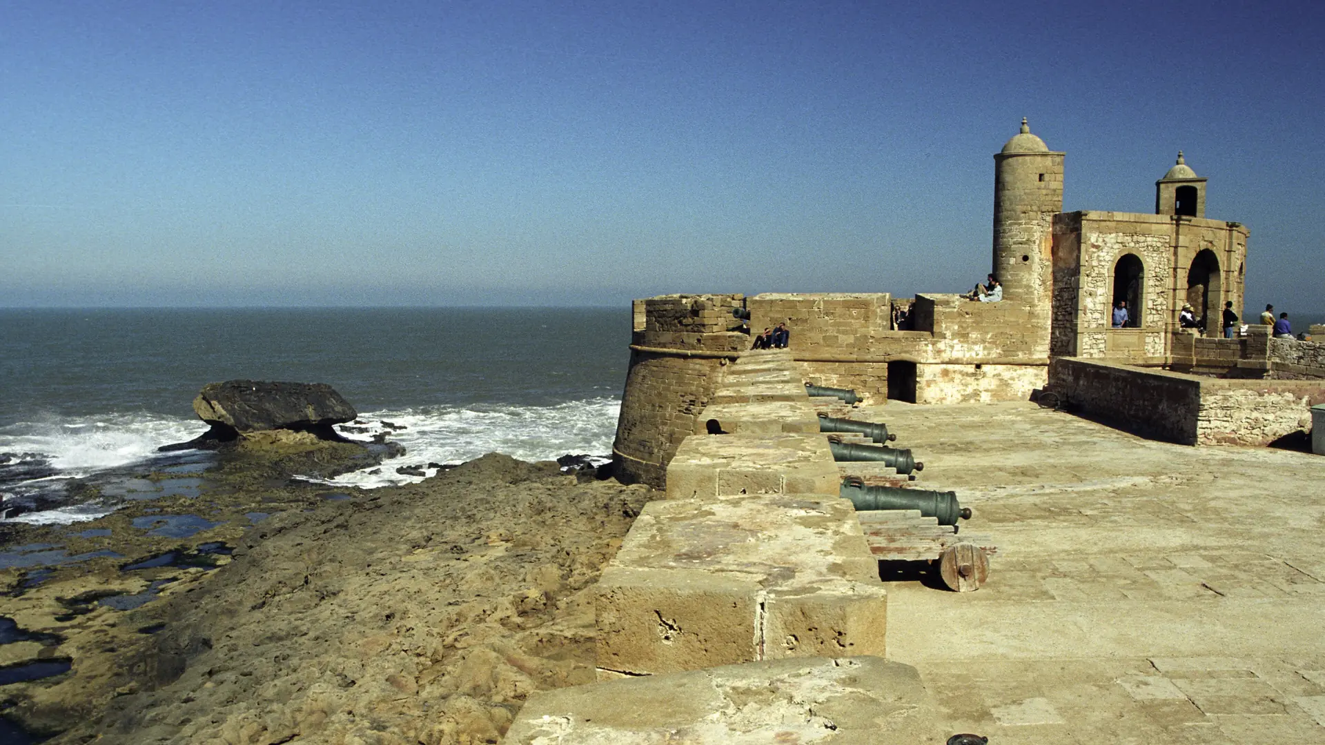 Sunlit stone ramparts and Atlantic water at Essaouira Skala