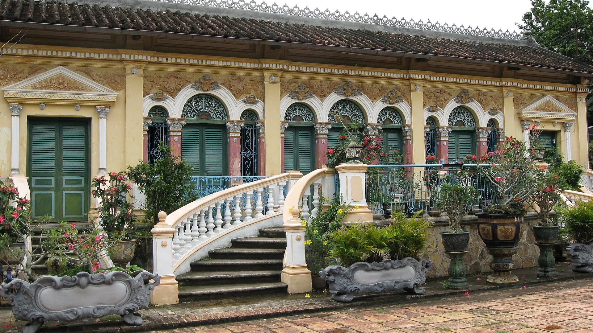 Binh Thuy house green shutters and white staircase